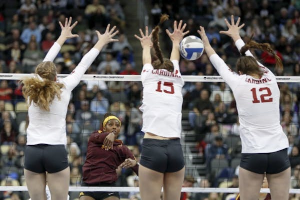 Staford's Holly Campbell, left, Madeleine Gates (15) and Audriana Fitzmorris (12) go up to block a hit by Minnesota's Alexis Hart during the semifinal