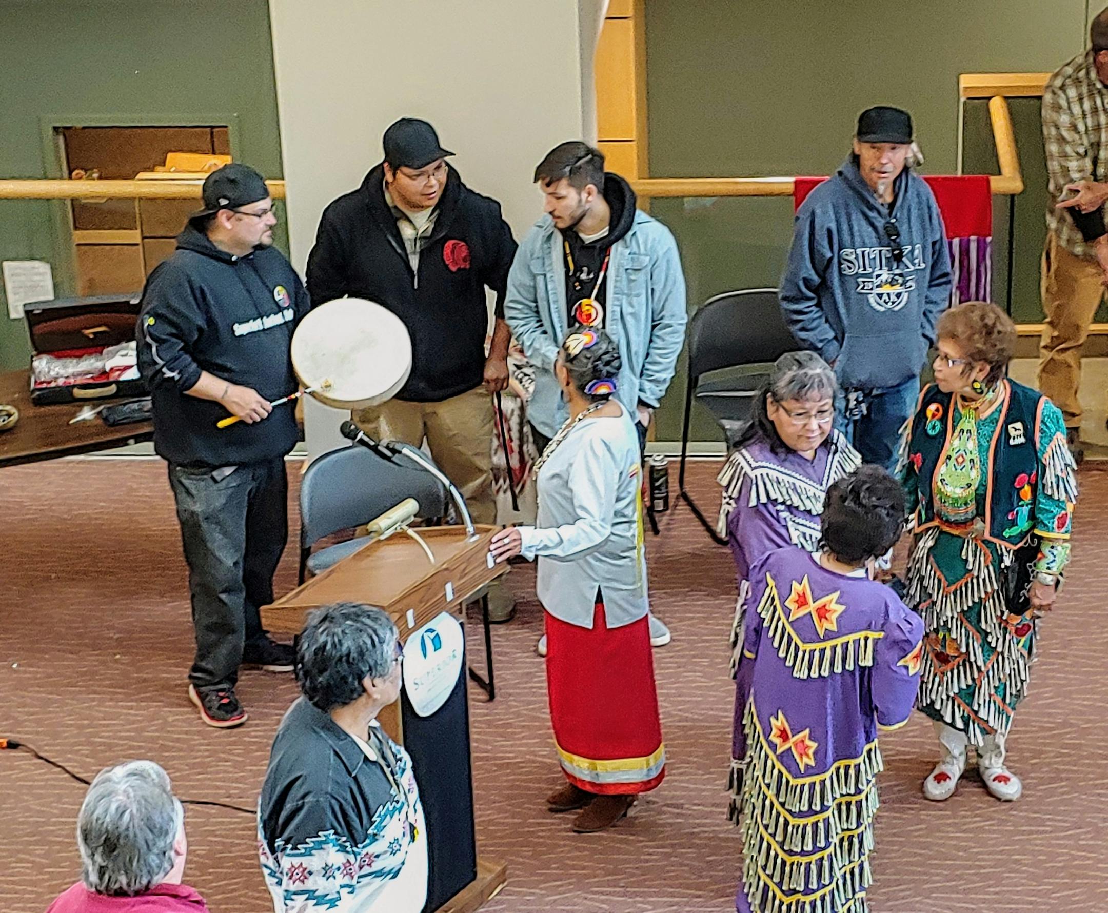 From left, drummers Troy Howes, Greywind Boshey and Dakota Oothoudt prepare for a round dance at the first official Indigenous Peoples Day celebration in Superior City Hall.