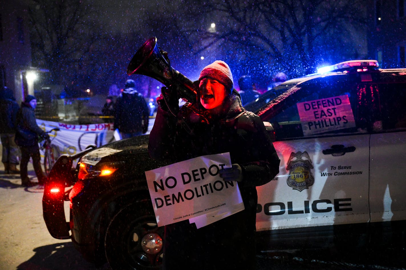 A protester chants anti-police slogans and against the planned demolition of the Roof Depot building Tuesday, Feb. 21, 2023 on Cedar Avenue and East 27th Street in Minneapolis, Minn. East Phillips neighborhood activists, including residents of the Little Earth of United Tribes housing complex for Native Americans, protested after Minneapolis Police cleared and arrested protesters who set up more than a dozen tents at the Roof Depot building Tuesday morning. ] AARON LAVINSKY • aaron.lavinsky@startribune.com