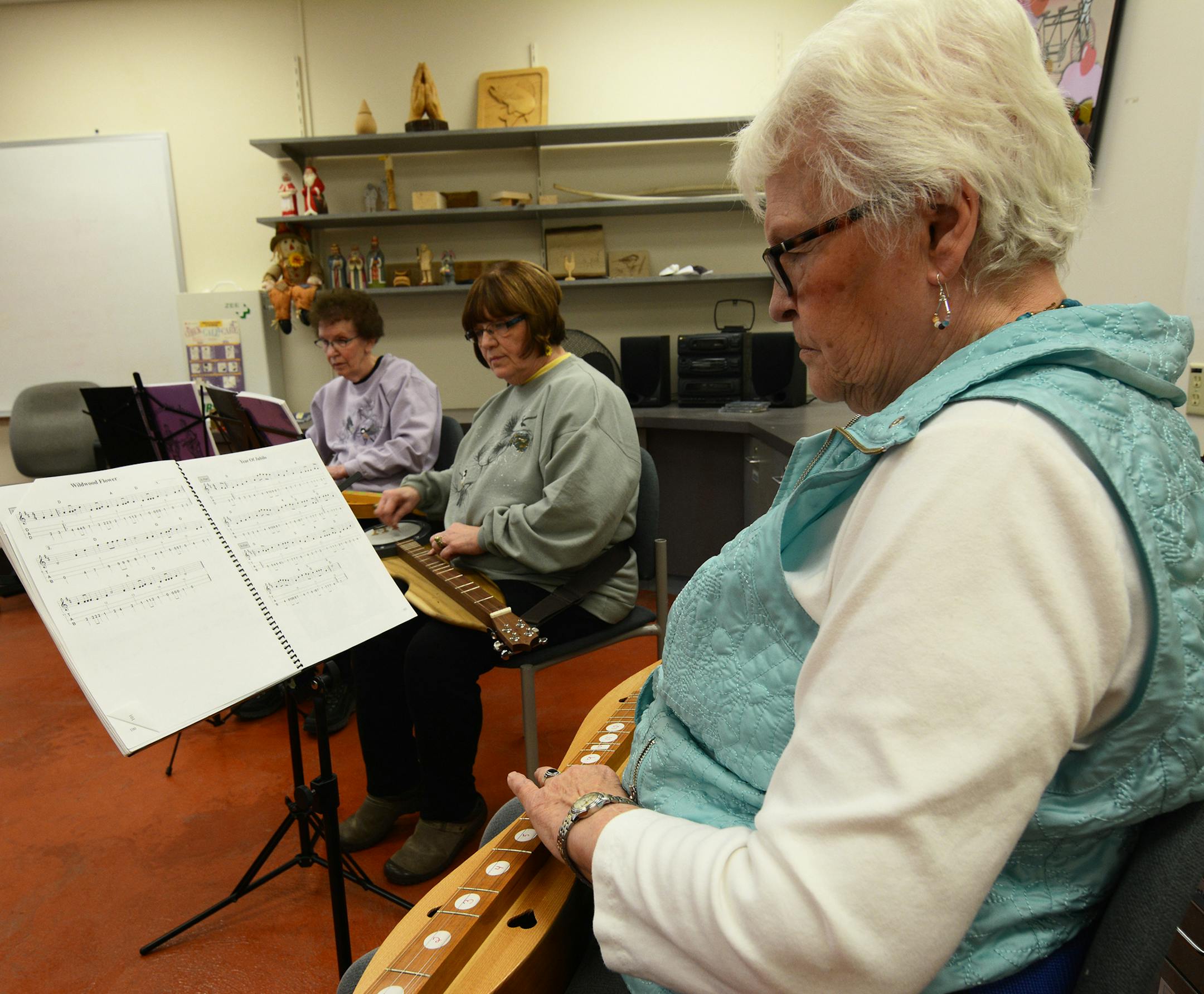 (left to right) Farmington residents Ruth Olson, Kathy Gunderson, and Alleen Wicktor are members of the new dulcimer club at the Rambling River Center. Liz Rolfsmeier, Special to the Star Tribune