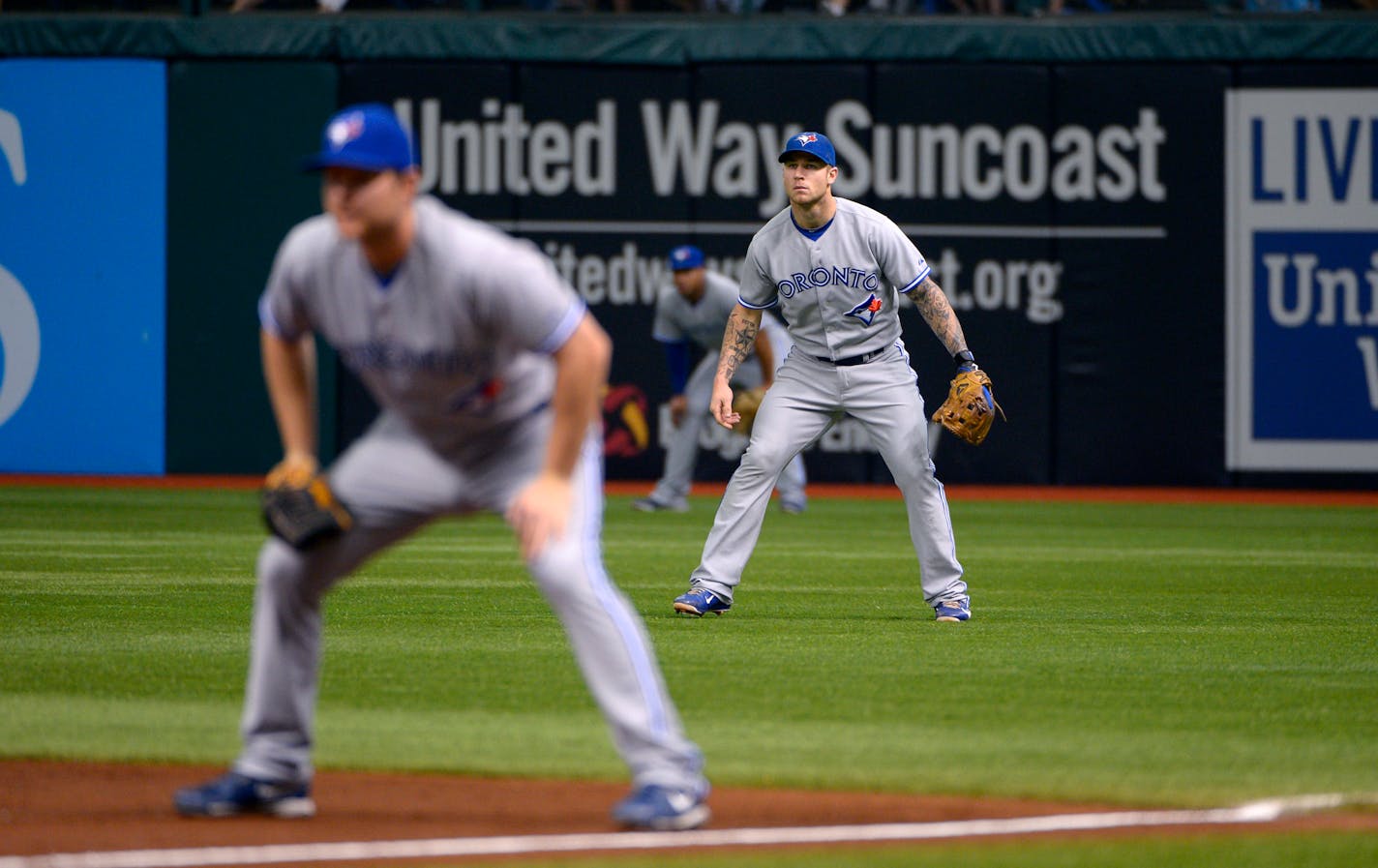 Toronto Blue Jays third baseman Brett Lawrie, middle, sets up between first baseman Adam Lind, left, and right fielder Moises Sierra in shallow right field as the team shifts to the right side as Tampa Bay Rays' Carlos Pena bats during the second inning of a baseball game in St. Petersburg, Fla., Sunday, Sept. 23, 2012. The Rays won 3-0.(AP Photo/Phelan M. Ebenhack) ORG XMIT: NYOTK