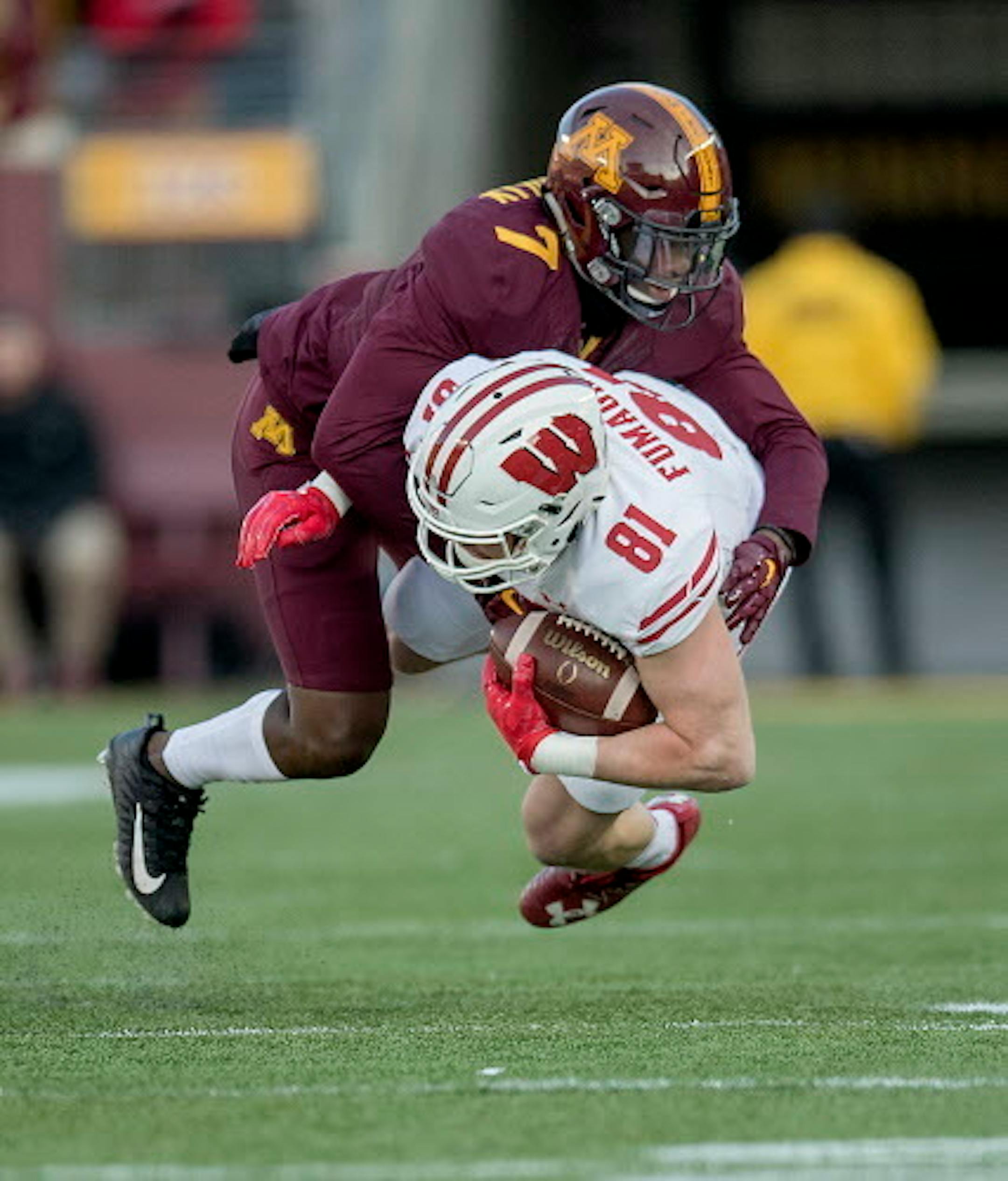 Minnesota's defensive back Ken Handy-Holly tackled Wisconsin's tight end Troy Fumagalli during the first quarter as Minnesota took on Wisconsin at TCF Bank Stadium, Saturday, November 20 2017 in Minneapolis, MN.   ]  ELIZABETH FLORES ' liz.flores@startribune.com