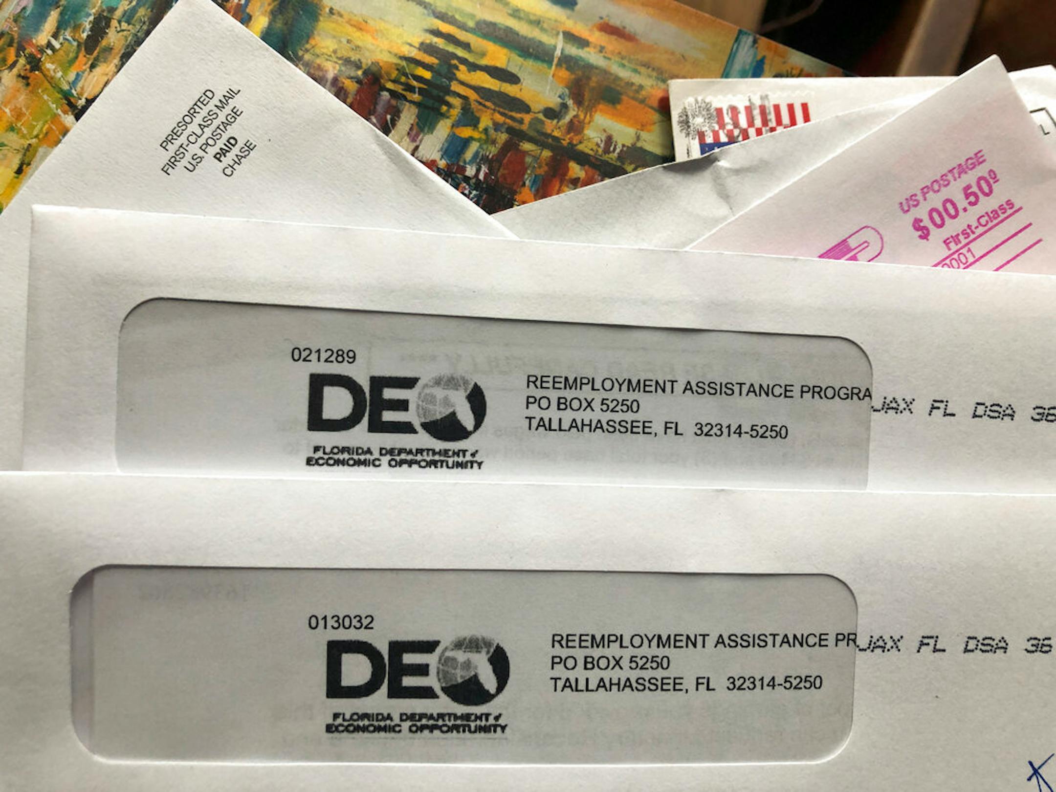 Envelopes from the Florida Department of Economic Opportunity Reemployment Assistance Program are shown, Thursday, Nov. 5, 2020, in Surfside, Fla. The number of a Americans applying for unemployment benefits rose last week to 778,000, evidence that the U.S. economy and job market remain under strain as coronavirus cases surge and colder weather heighten the risks.