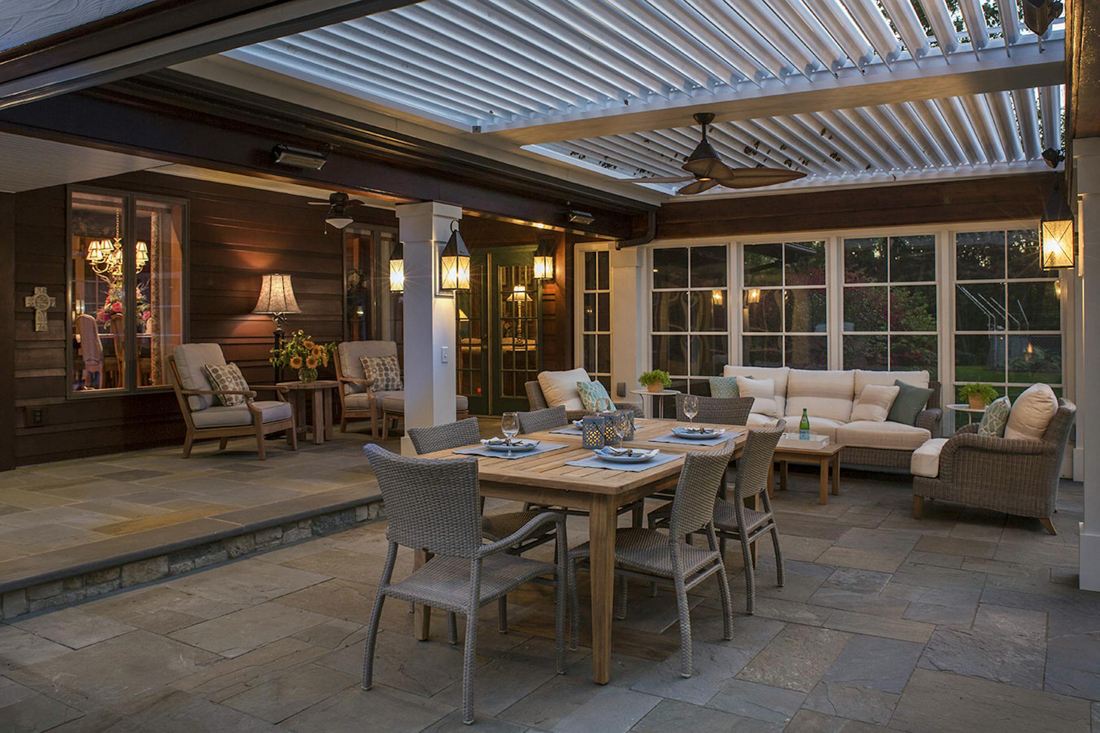 The new pergola adjoins the original porch, left, which was too small for big family gatherings.