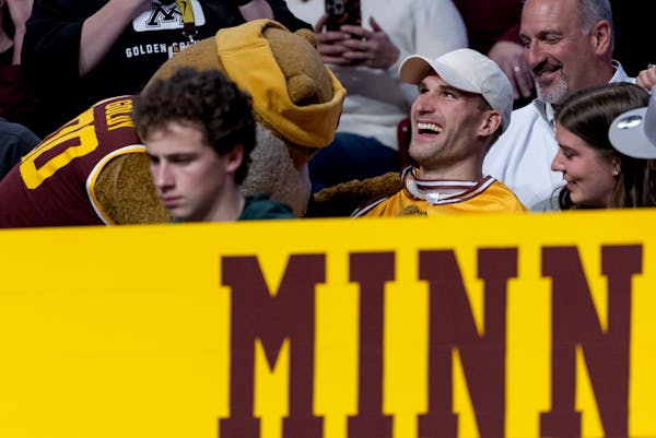 Gophers mascot Goldy Gopher attempted to place a Minnesota jersey on former Michigan State quarterback Kirk Cousins during a game vs. the Spartans Tue