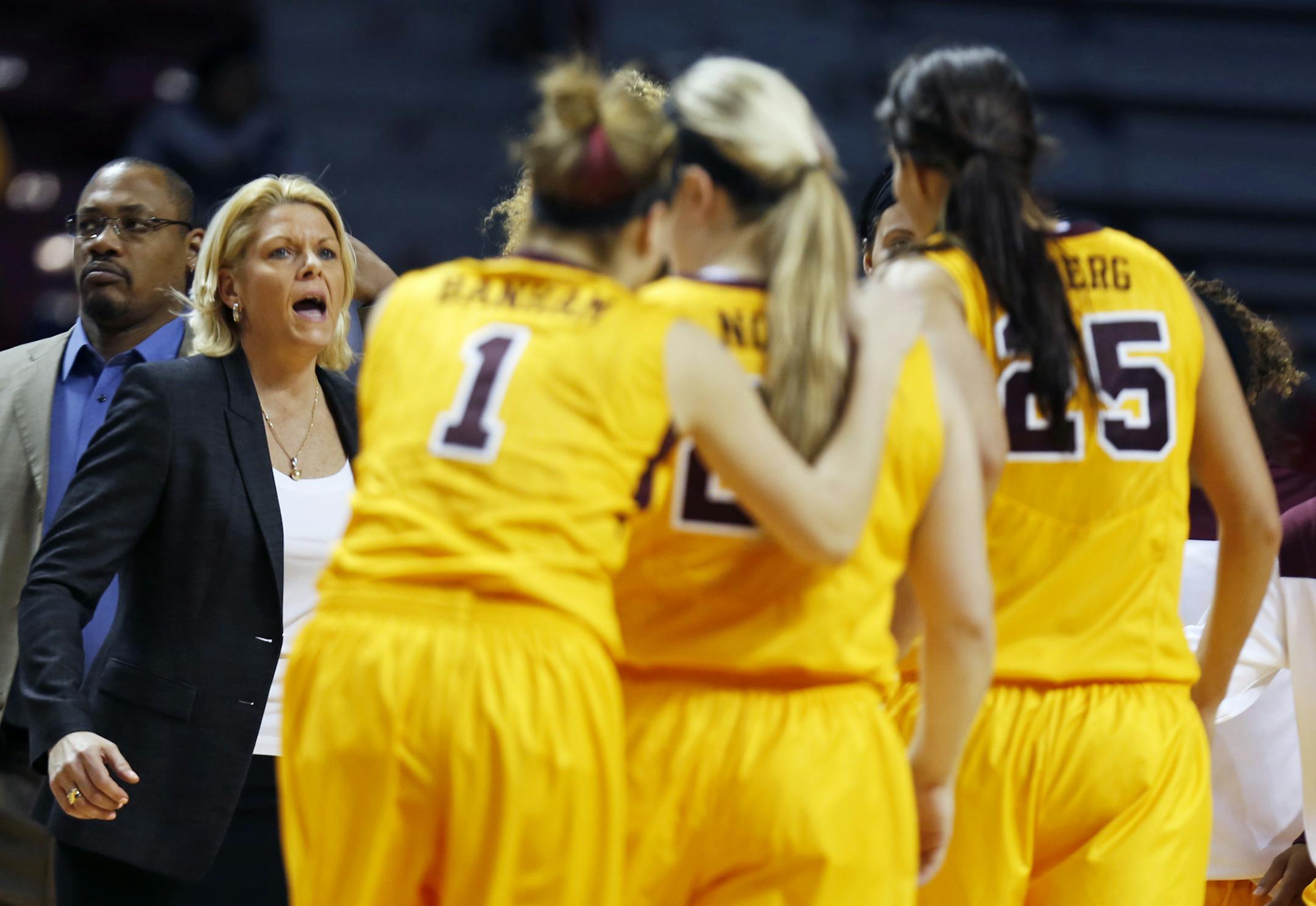 At the Williams Arena in a game between Penn State and the U of M women's basketball team, U of M head coach Pam Borton exhorted her troops during a timeout .