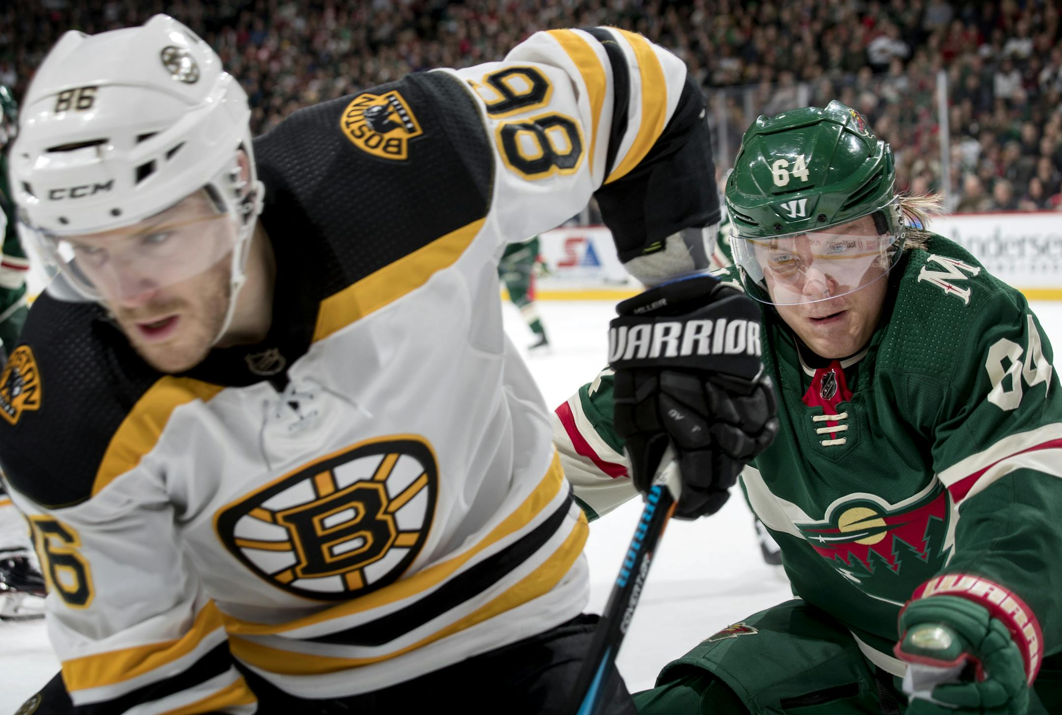 Kevan Miller (86) and Mikael Granlund (64) chased the puck in the corner during the first period. ] CARLOS GONZALEZ &#xef; cgonzalez@startribune.com &#xf1; March 25, 2018, St. Paul, MN, Xcel Energy Center, NHL, Hockey, Minnesota Wild vs. Boston Bruins