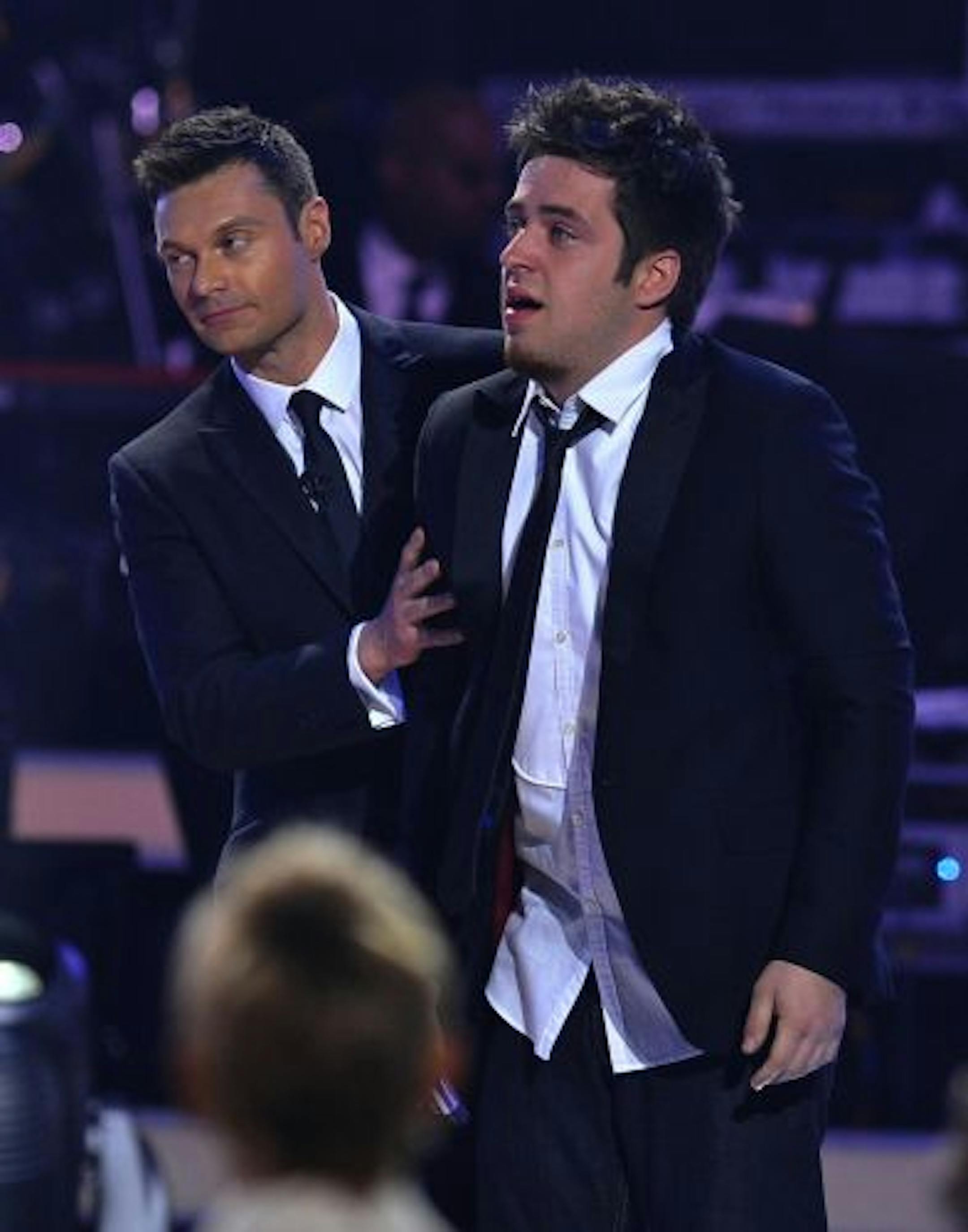 Lee DeWyze, right, reacted after he was named the winner of "American Idol" by host Ryan Seacrest.