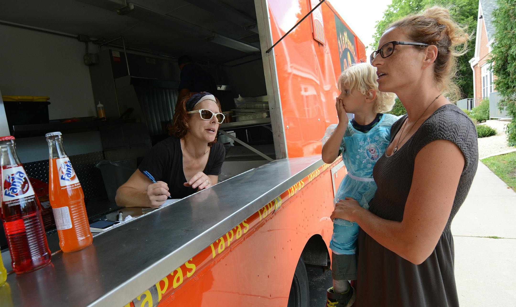 Arlo and Amanda Eastvold ordered from Anna Peterson, of A La Plancha, at a recent Food Truck Tuesday in Northfield. This is Peterson’s second time serving food at the new weekly event. “I love it,” she said. Photo by Liz Rolfsmeier, Special to the Star Tribune