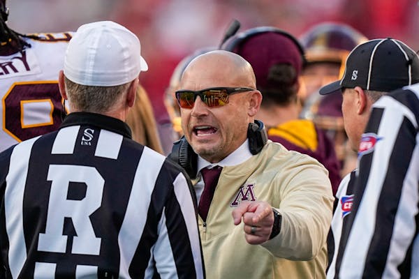 Gophers coach P.J. Fleck talked with officials during a timeout in the first half Saturday against Wisconsin.