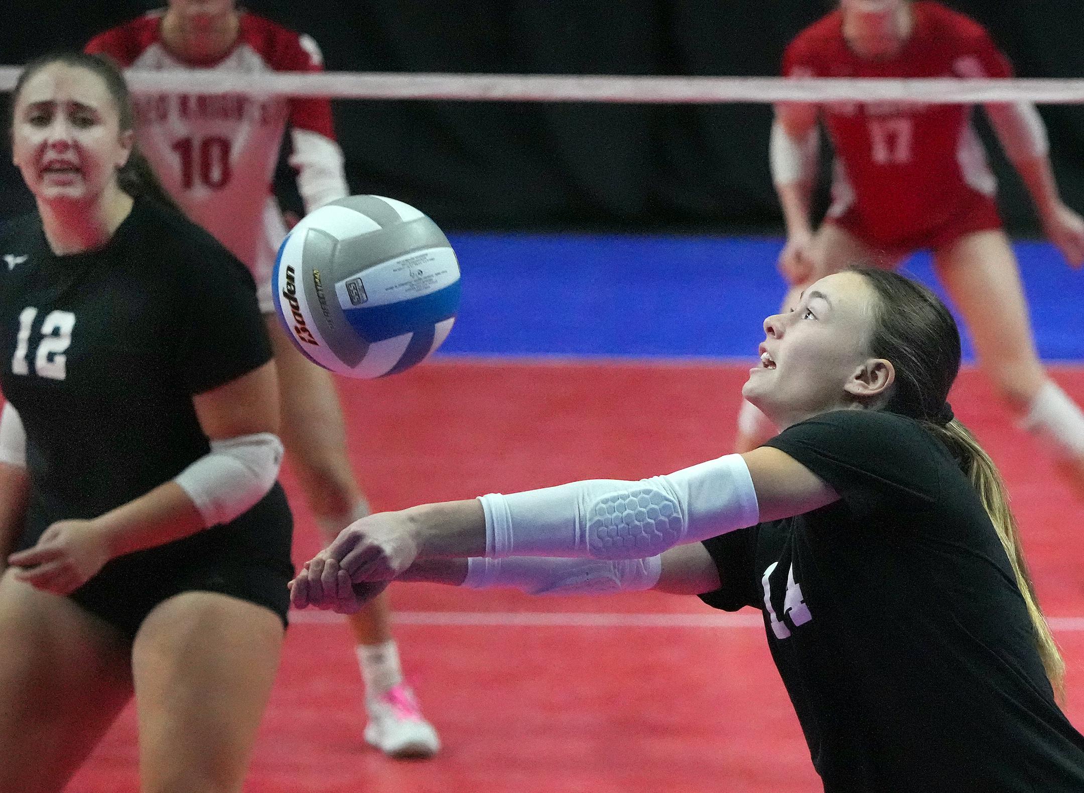 Kasson-Mantorville's Ellie Ask (14) bumps a shot against Benilde-St. Margaret's.