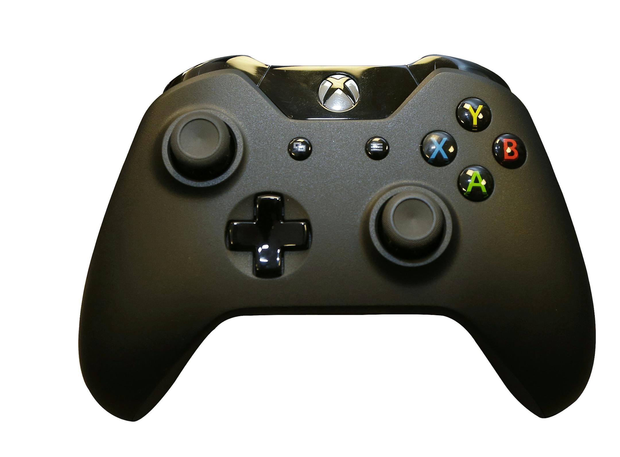 The new controller for Microsoft's next-generation Xbox One entertainment and gaming console system is shown front and center with older-generation controllers behind it, Tuesday, May 21, 2013, in Redmond, Wash. (AP Photo/Ted S. Warren) ORG XMIT: WATW131