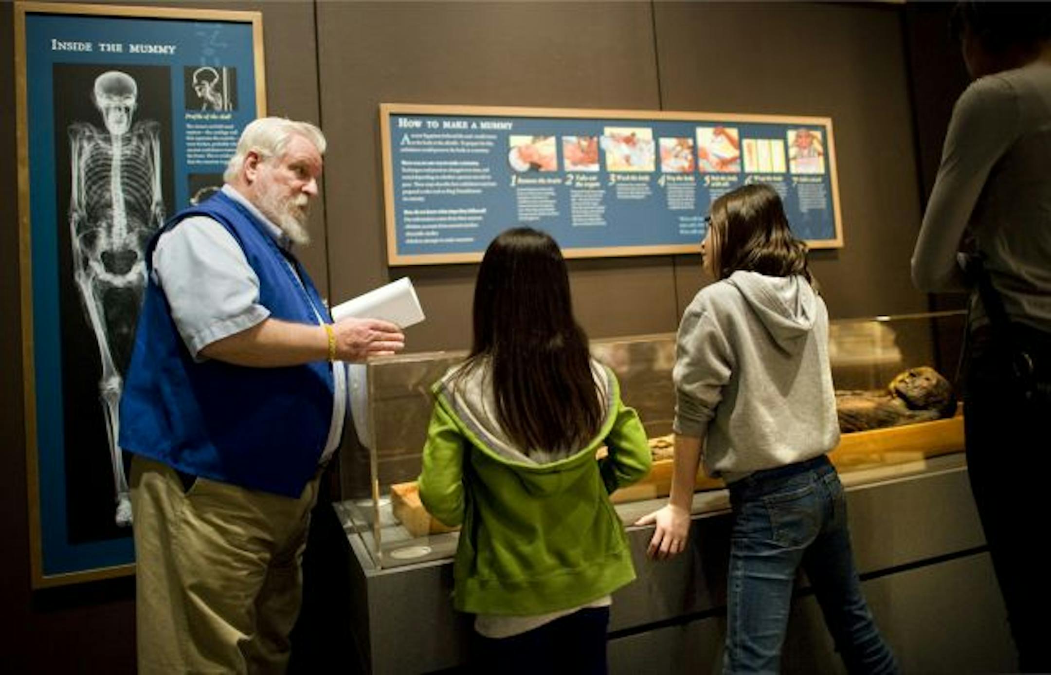 Loren Garlets, a volunteer at the Science Museum of Minnesota, answered questions from Olivia Leighton and Kirra Tjeltveit, who were visiting the museum on a school trip.