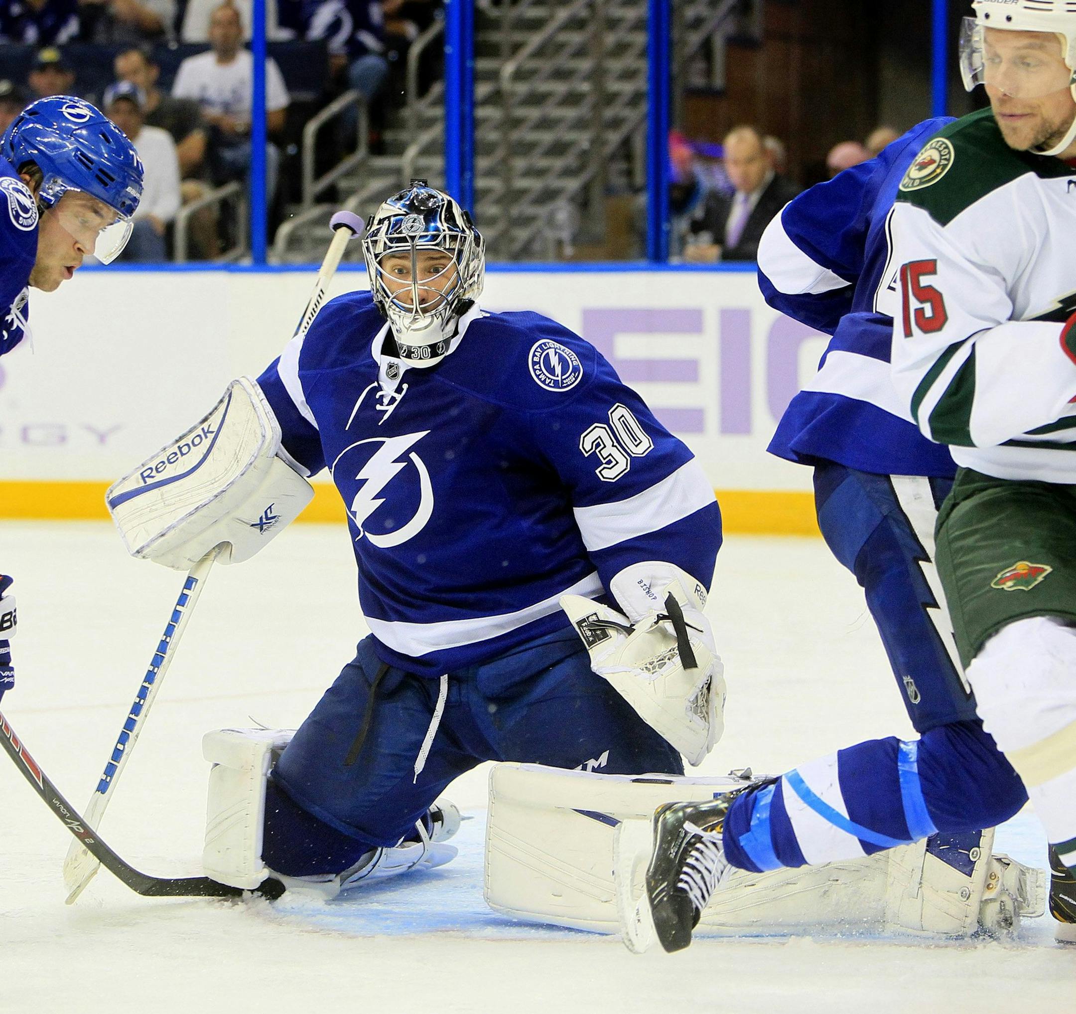 Tampa Bay Lightning goalie Ben Bishop (30) defends his net with teammate Victor Hedman (77) as the Minnesota Wild's Dany Heatley (15) pressures in the second period at the Tampa Bay Times Forum in Tampa, Florida, on Thursday, October 17, 2013. The Lightning won, 3-1. (Dirk Shadd/Tampa Bay Times/MCT)