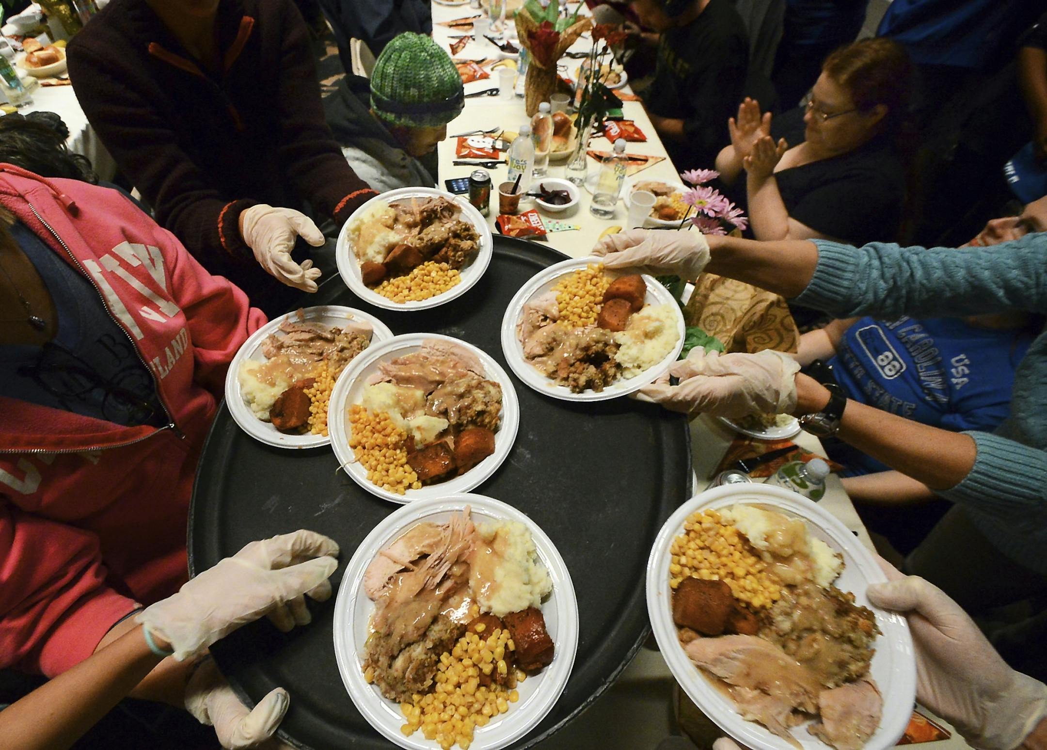 Plates of hot turkey dinners with all the trimmings are taken by volunteers to serve over 1,000 residents during the 40th annual Friends of the Poor Thanksgiving Community Dinner at the Scranton Cultural Center, Tuesday, Nov. 22, 2016, in downtown Scranton, Pa.