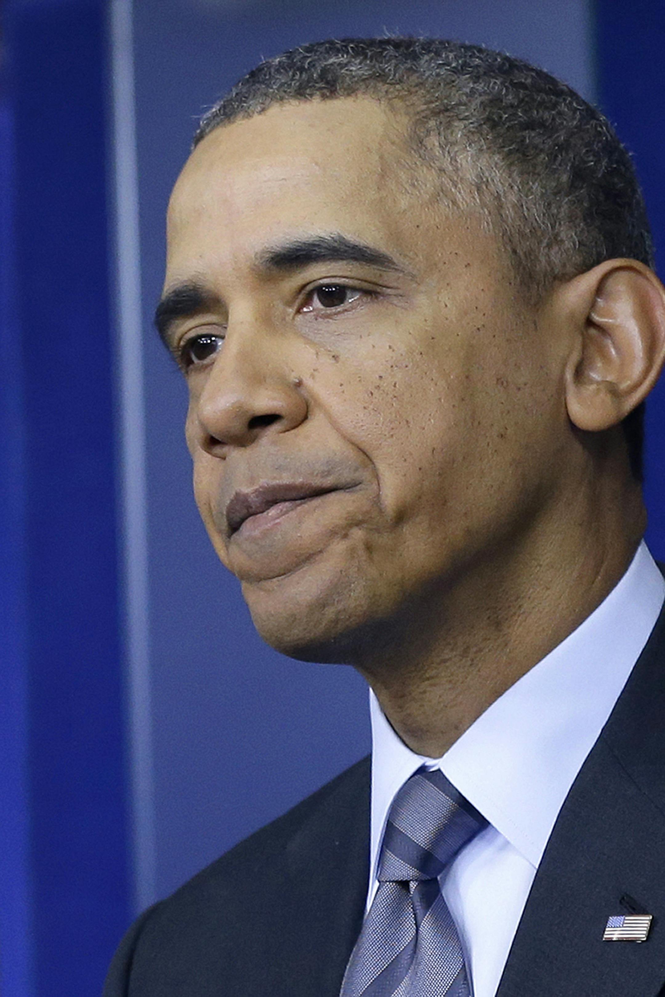 President Barack Obama pauses as he talks about the situation in Ukraine, Thursday, March 6, 2104, in the briefing room of the White House in Washington. The president said a referendum for Ukraine's Crimea region to separate and become part of Russia would violate international law. (AP Photo/Manuel Balce Ceneta)