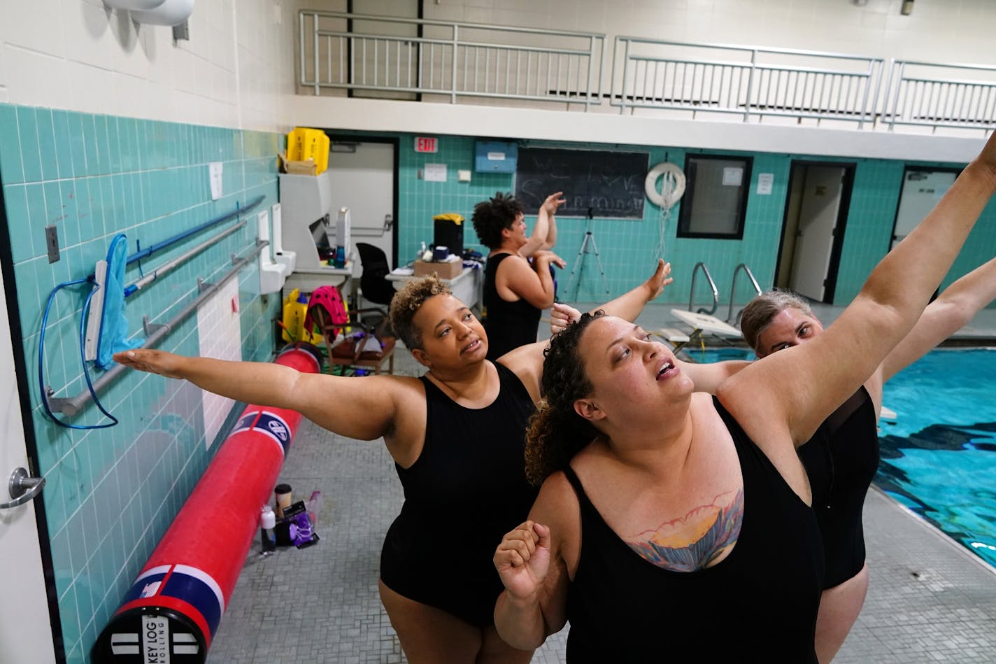 Zoe Hollomon, at front, and her fellow Subversive Sirens went through their routine on the pool deck before getting in the water.