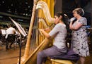 Minnesota Orchestra harpist Kathy Kienzle, right, mentors Cuban harpist Anabel Gutierrez, who is headed to Indiana University to study in the fall, at