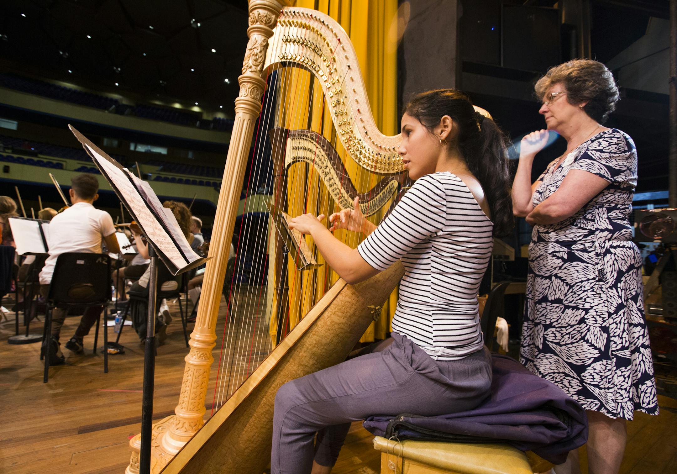 Minnesota Orchestra harpist Kathy Kienzle, right, mentors Cuban harpist Anabel Gutierrez, who is headed to Indiana University to study in the fall, at the Teatro Nacional in Havana, Cuba during a side-by-side rehearsal on Friday, May 15, 2015. ] LEILA NAVIDI leila.navidi@startribune.com /