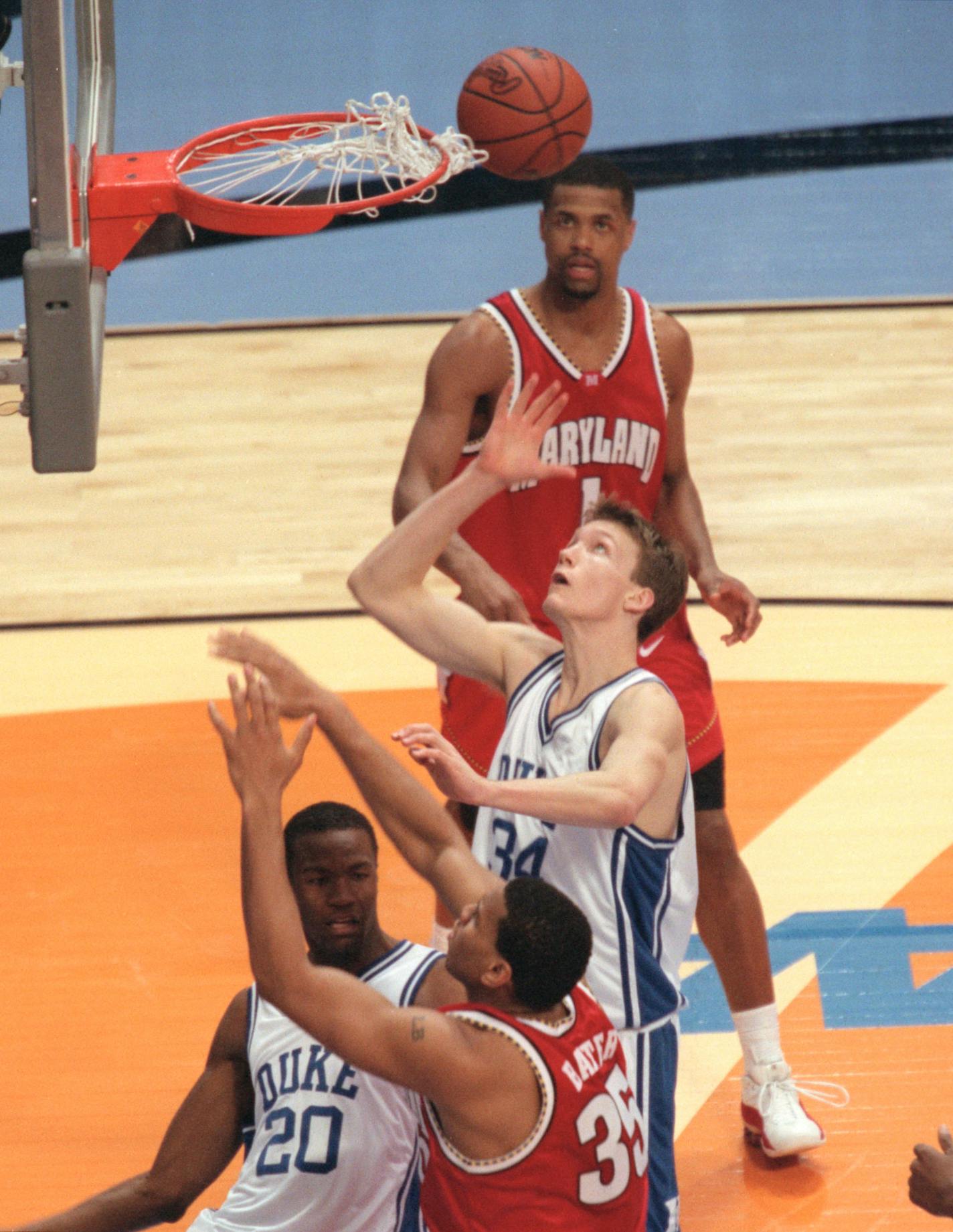 Maryland's Lonny Baxter attempts a shot and is blocked by Casey Sanders, 20, front and Shane Battier, 31, of Duke University during play in the NCAA Final Four March 31, 2001 at the Metrodome in Minneapolis.