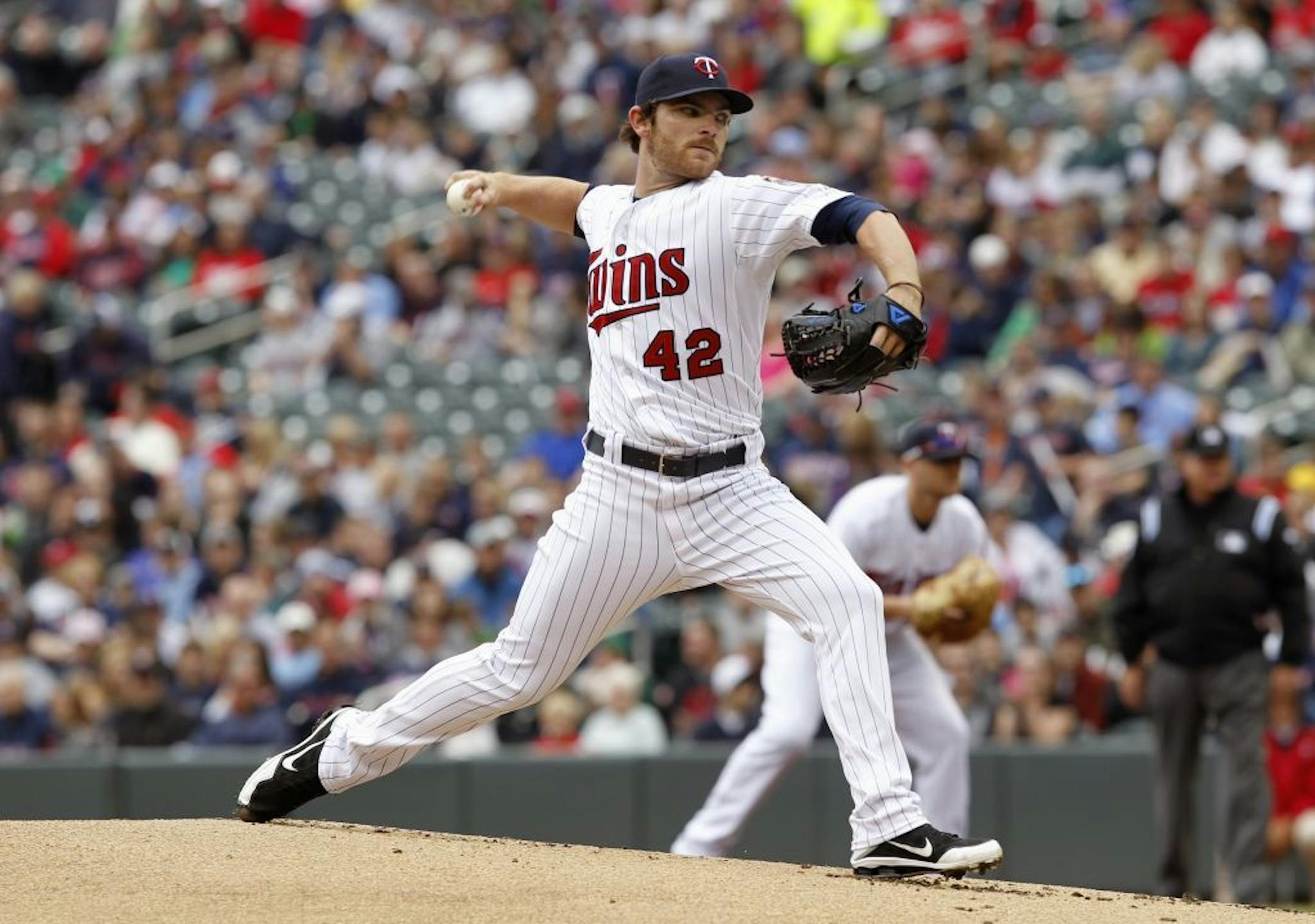 Minnesota Twins starting pitcher Liam Hendriks throws against theTexas Rangers during the first inning of a baseball game on Sunday, April 15, 2012, in Minneapolis. The players were all wearing No. 42 in honor of Jackie Robinson Day.
