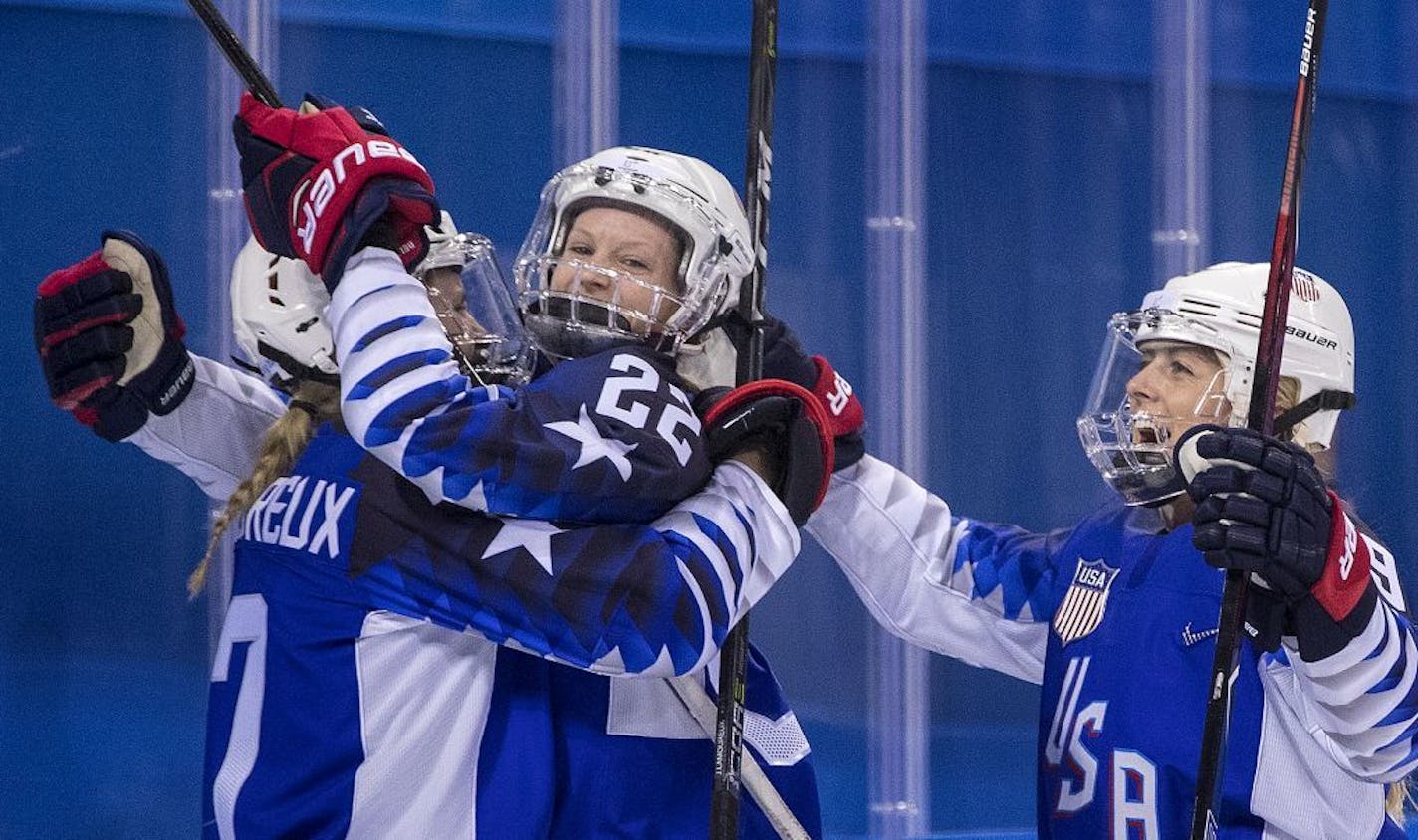 Kacey Bellamy (22) celebrated with teammates after scoring a goal in the first period.