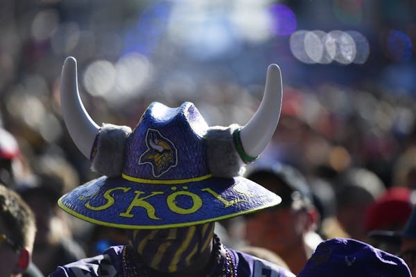 A Minnesota Vikings fan stands near the main stage ahead of the second round of the NFL football draft, Friday, April 26, 2019, in Nashville, Tenn.