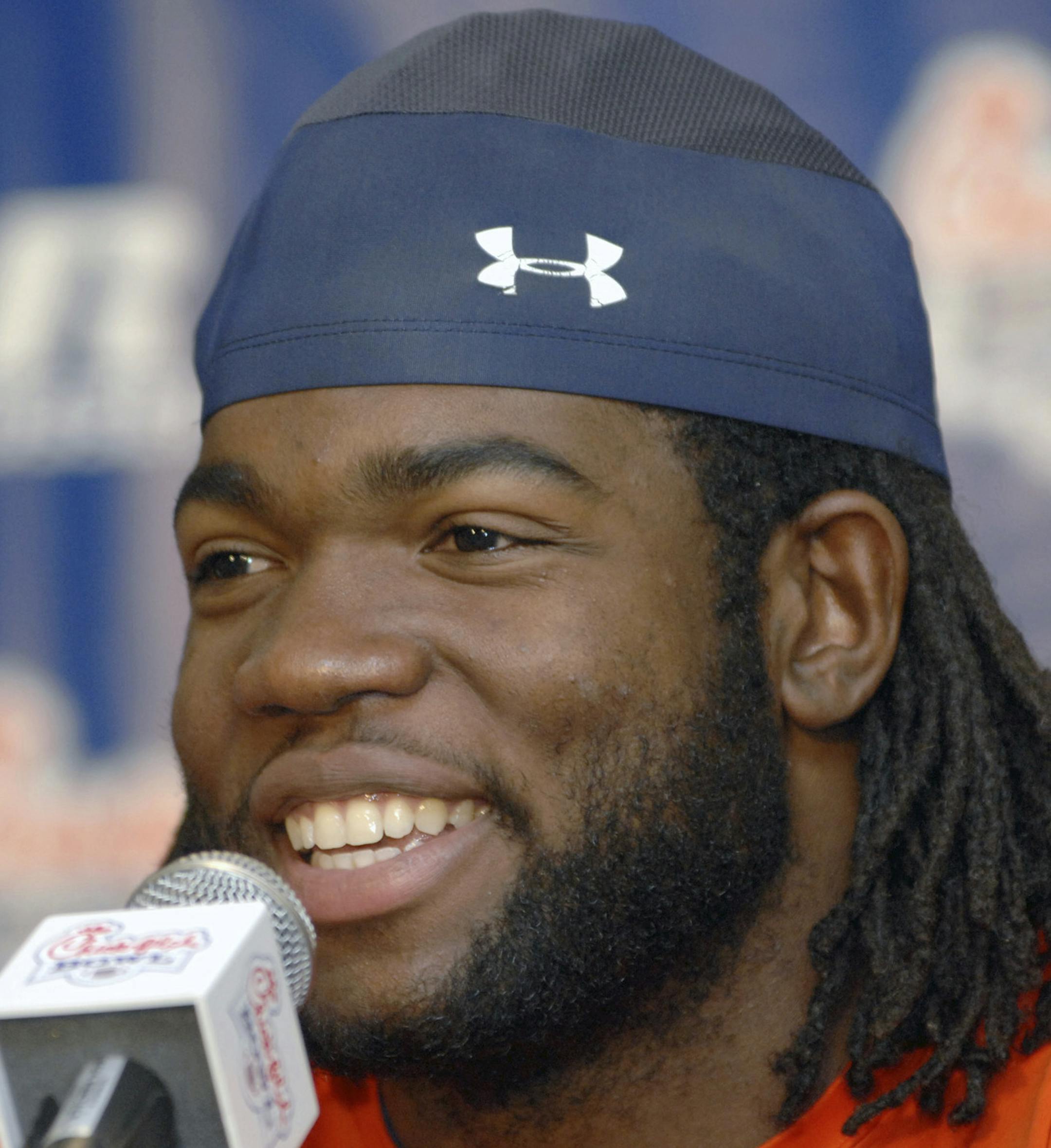 FILE - In this Dec. 28, 2007, file photo ,Auburn linebacker Quentin Groves smiles as he speaks during an NCAA college football news conference in Atlanta. Groves, who played defensive end for the Tigers from 2004-07 and shares the program record for sacks, died in his sleep while visiting Trinidad, his wife's native country, Auburn spokesman Kirk Sampson said Saturday, Oct. 15, 2016. He was 32. Sampson said he didn't know the cause of death. (AP Photo/Gregory Smith, File)