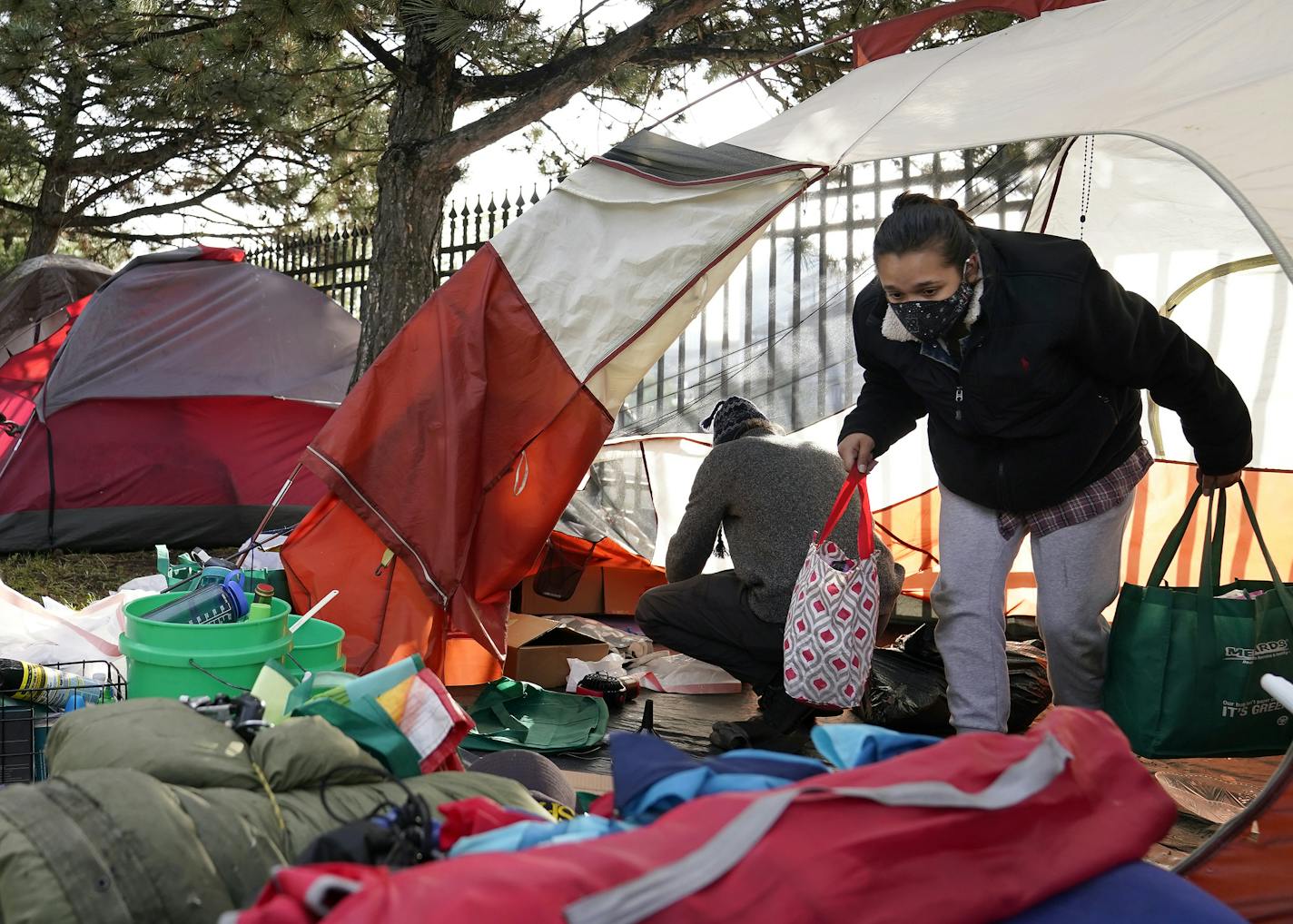 Mara, who wished not to have her last name used, a neighbor to a homeless encampment near downtown, helped cleared out the remaining tents and their contents in an encampment near I-35E Thursday in St. Paul. "This is my community... my people," Mara said.] DAVID JOLES • david.joles@startribune.com Thursday, Sept. 10, 2020, in St. Paul, MN St. Paul's Department of Safety and Inspections (DSI) will clear a tent encampment off I-35E Thursday morning near downtown St. Paul.