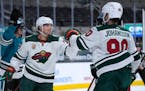 Wild left wing Kevin Fiala is congratulated by Marcus Johansson after scoring a goal against the San Jose Sharks during the second period