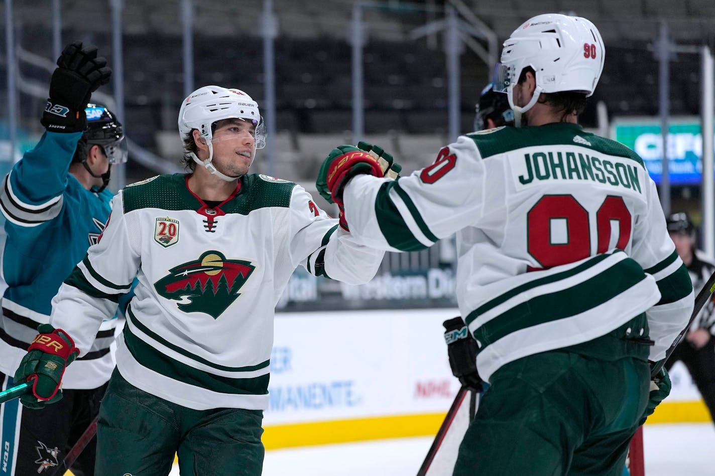 Wild left wing Kevin Fiala is congratulated by Marcus Johansson after scoring a goal against the San Jose Sharks during the second period