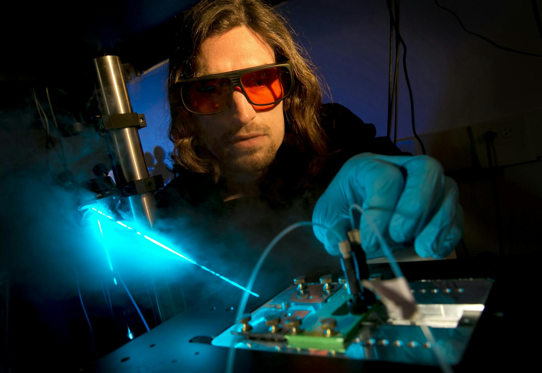 Stephen Jones, a molecular biology postdoctoral fellow, demonstrates the CHAMP, a device created for scientists to more safely use a new kind of gene editing technique called CRISPR, in the laboratory of UT professor Ilya Finkelstein on Aug. 11, 2017. (Jay Janner/Austin American-Statesman/TNS)
