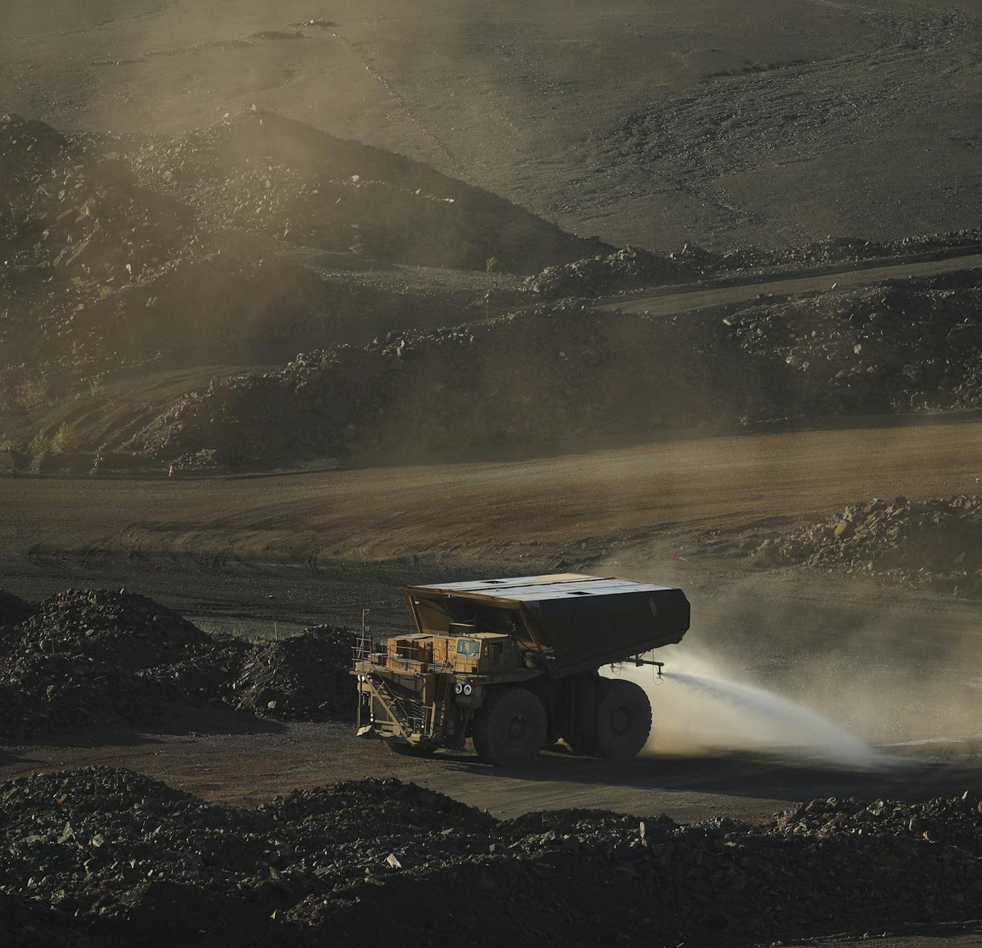 A truck sprayed water on a road in part of the Hull-Rust-Mahoning Mine to keep dust down Wednesday evening in Hibbing. ] JEFF WHEELER &#xef; jeff.wheeler@startribune.com The economy on the Iron Range is in a boom cycle currently with mines operating and new business betting on the current upswing lasting. The Boomtown Brewery & Woodfire Grill was photographed during the busy Wednesday dinner rush on June 13, 2018 in downtown Hibbing.