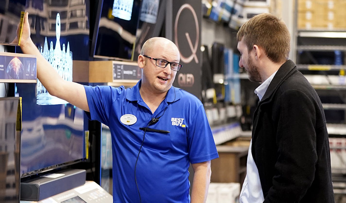 Best Buy sales consultant Jon Hollywood talked with customer Josh Watson, right, who was visiting from Midland, Michigan, about television options. ] LEILA NAVIDI &#x2022; leila.navidi@startribune.com BACKGROUND INFORMATION: Best Buy in Richfield on Thursday, November 21, 2019.