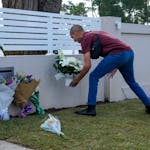 A man places flowers outside the Christ the Good Shepherd church in suburban Wakely in western Sydney, Australia, Tuesday, April 16, 2024. Australian 