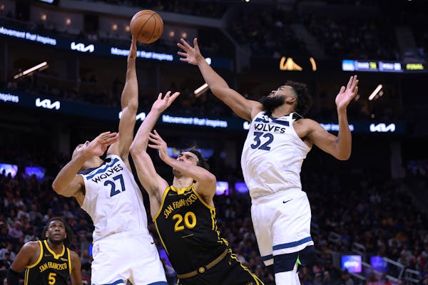 Warriors forward Dario Saric was in trouble as the Wolves’ Rudy Gobert and Karl-Anthony Towns thwarted him Nov. 14 in San Francisco.