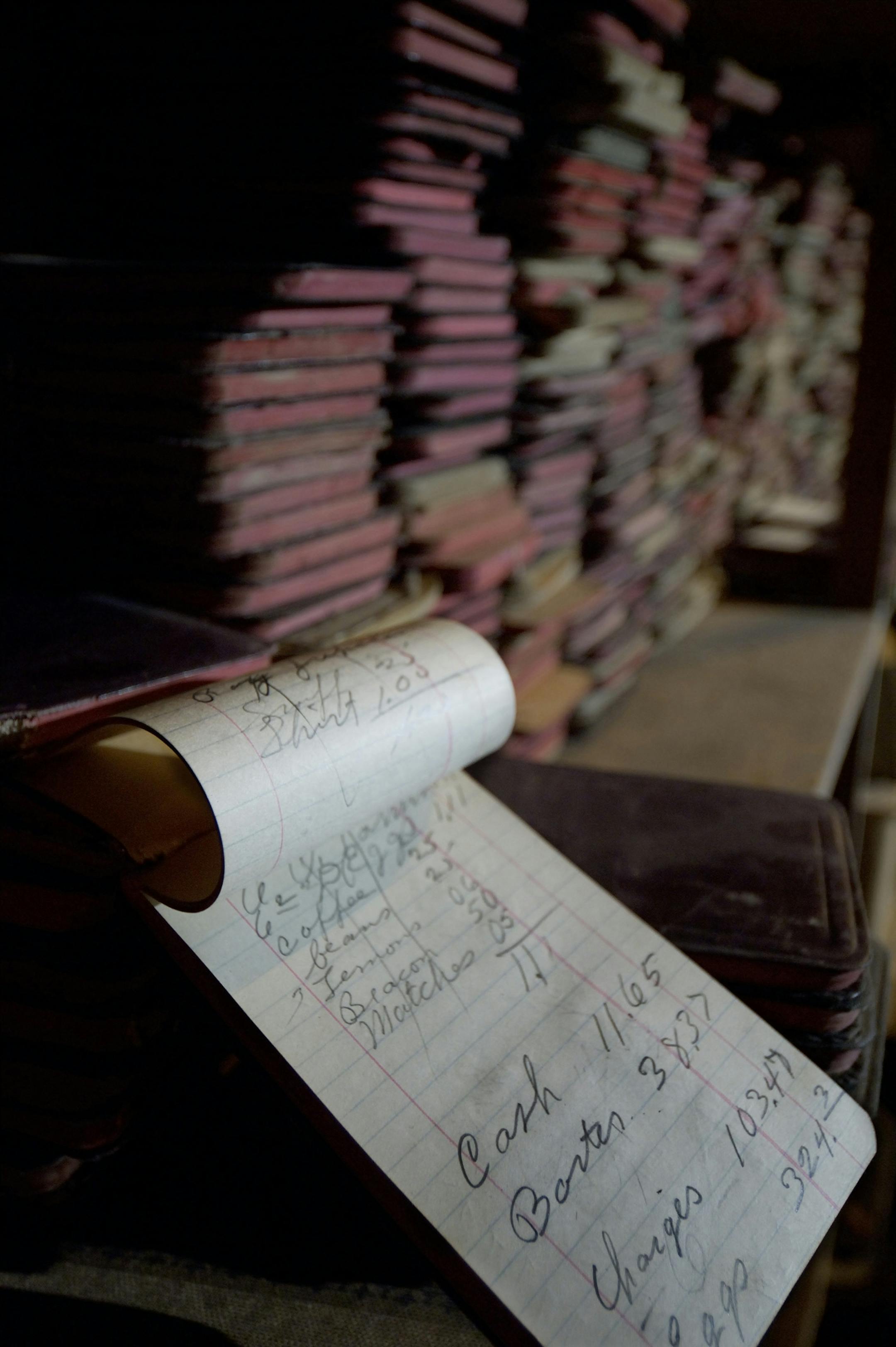 David Brewster/StarTribune Wednesday_08/24/05_Godahl - - - - - - - What's billed as Minnesota's oldest continuously operating coop store is in danger of going out of business in tiny Godahl, 30 miles west of Mankato. THIS PHOTO / In the Godahl Store 2nd floor storage room are lots of examples of its operation from years past. Seen here in the foreground is a receipt book from June of 1916 pulled from stacks of receipt books (in background) from the early part of the last century.