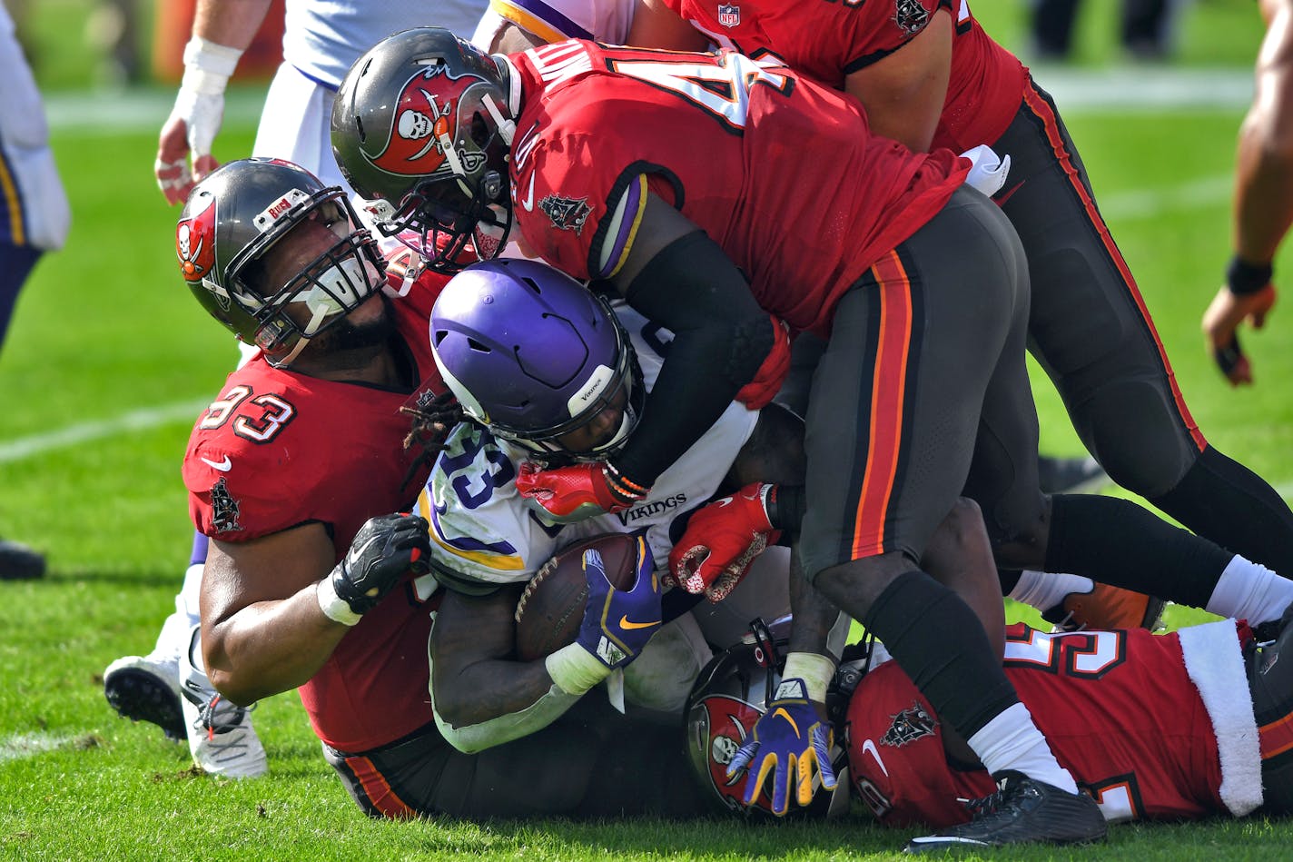 Tampa Bay Buccaneers defensive end Ndamukong Suh (93) and inside linebacker Devin White (45) team up to stop Minnesota Vikings running back Dalvin Cook (33) during the first half of an NFL football game Sunday, Dec. 13, 2020, in Tampa, Fla. (AP Photo/Jason Behnken)