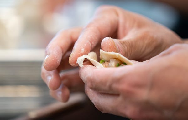 Peter Bian, co-founder of Saturday Dumpling Co., assembles a pork, shrimp and chive dumpling.