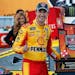 Joey Logano stood with the trophy after winning a NASCAR Cup Series race at Michigan International Speedway on Monday.