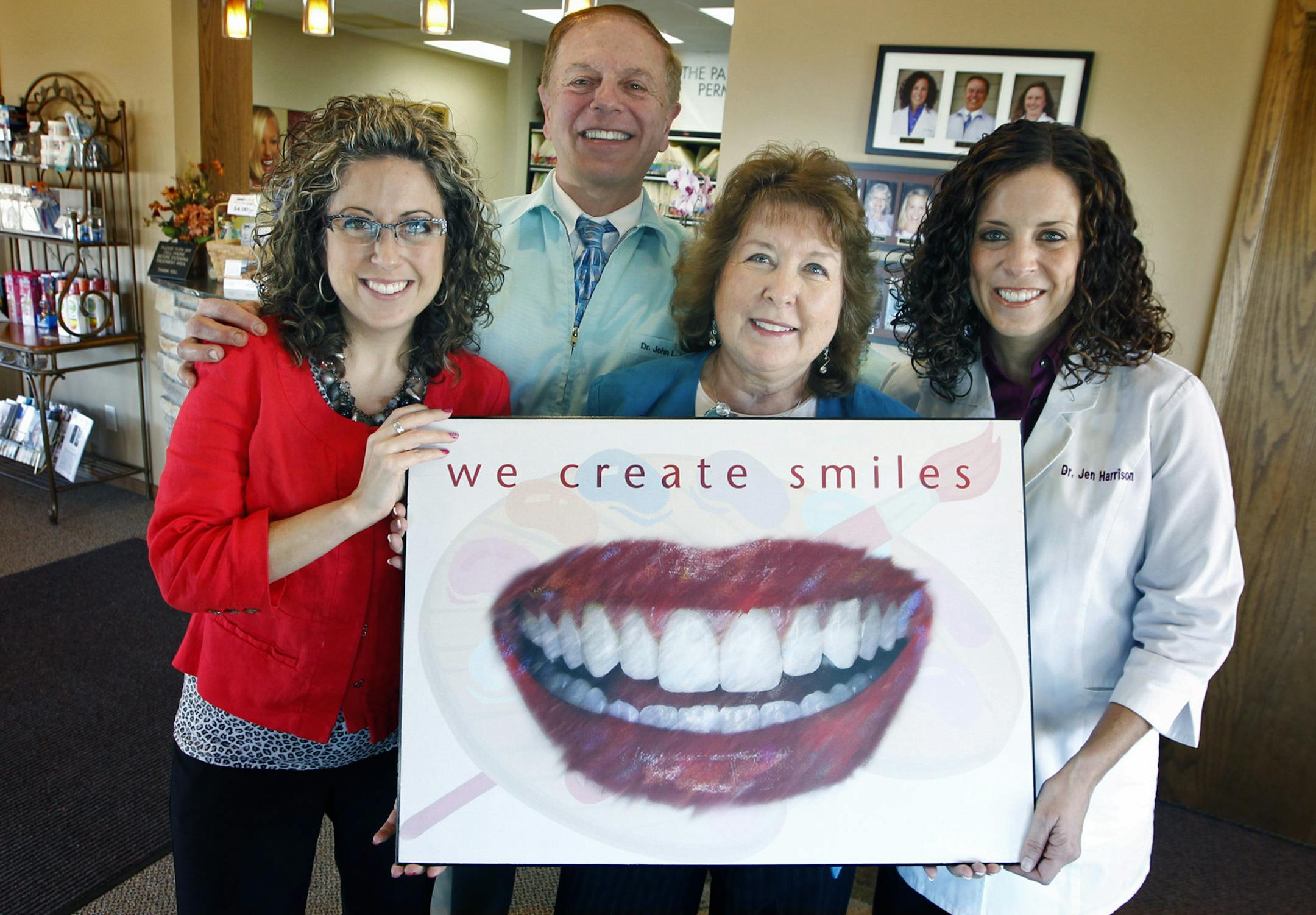 Dr. John Harrison, hugged his family and dental team, Molly, left, his wife Rose, center, and Jennifer at Lakeville Dental, Wednesday, November 6, 2013 in Lakeville, MN. Lakeville Dental is one of three Lakeville businesses on County Road 50, all in a row, are all family-owned, with second- or third-generation family members working there. McDonald Eye Care, Lakeville Dental and White Funeral Homes all have children in their 20s and 30s who went to college and then returned to Lakeville to join