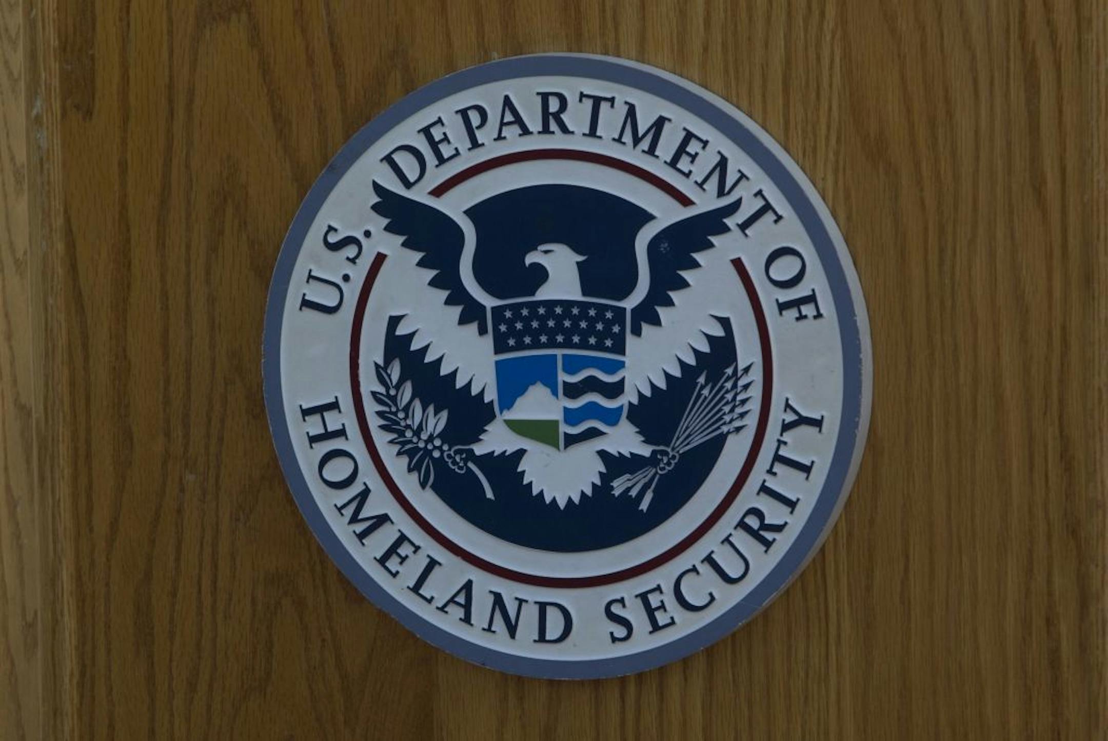 The Department of Homeland Security logo hangs in San Diego during a news conference on October 26, 2017.