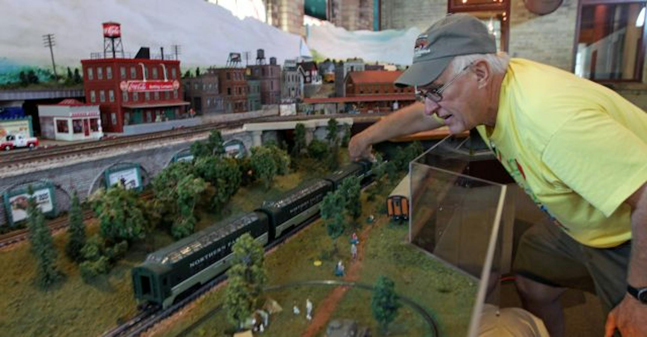 Chad Kono placed O-gauge model rail cars on the recently acquired Milwaukee Road layout at the Model Railroad Museum in St. Paul. Kono helped move the layout out of a California house.