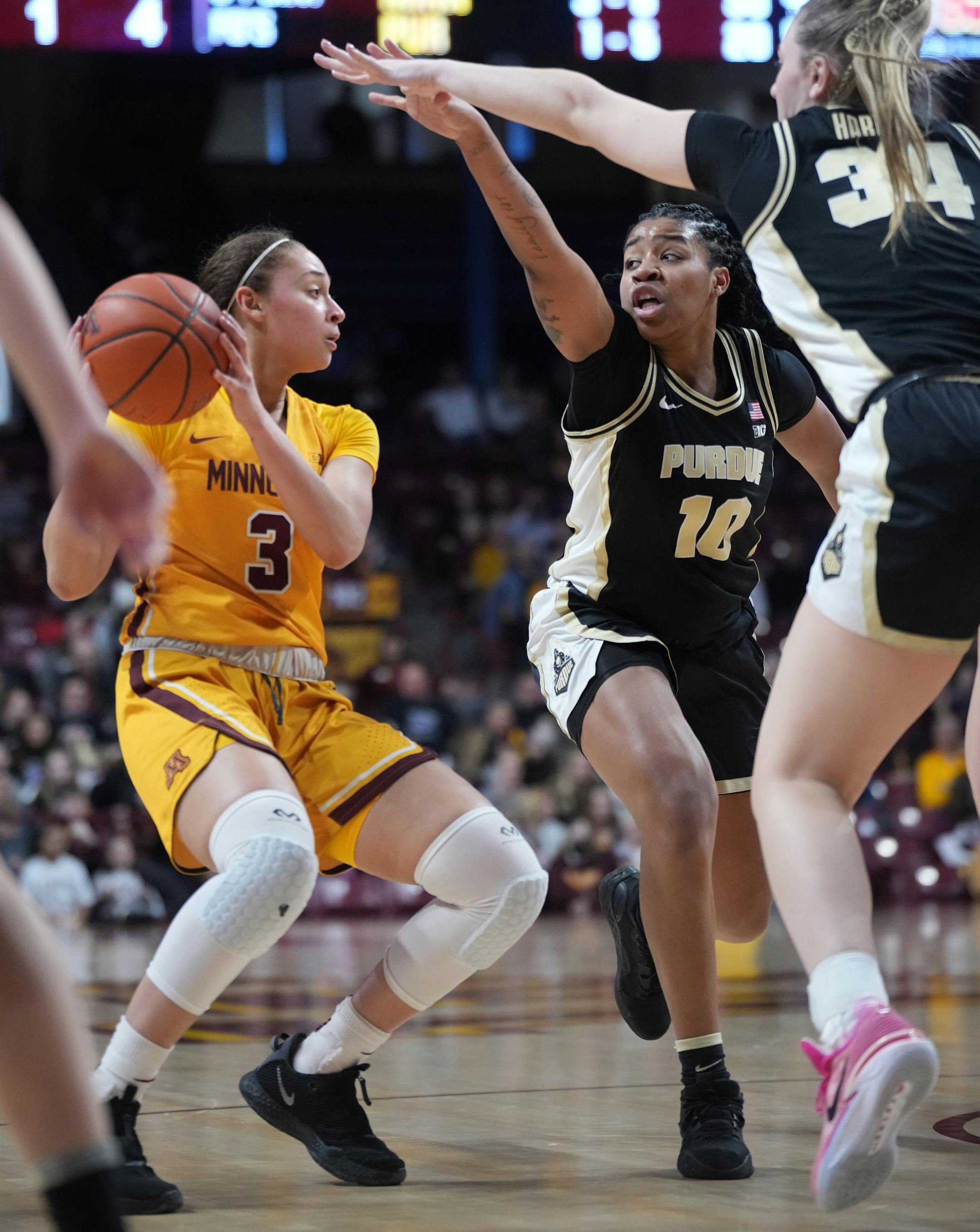 Minnesota Gophers' Amaya Battle (3) is defended by Purdue guard Jeanae Terry (10) and Purdue forward Caitlyn Harper (34).