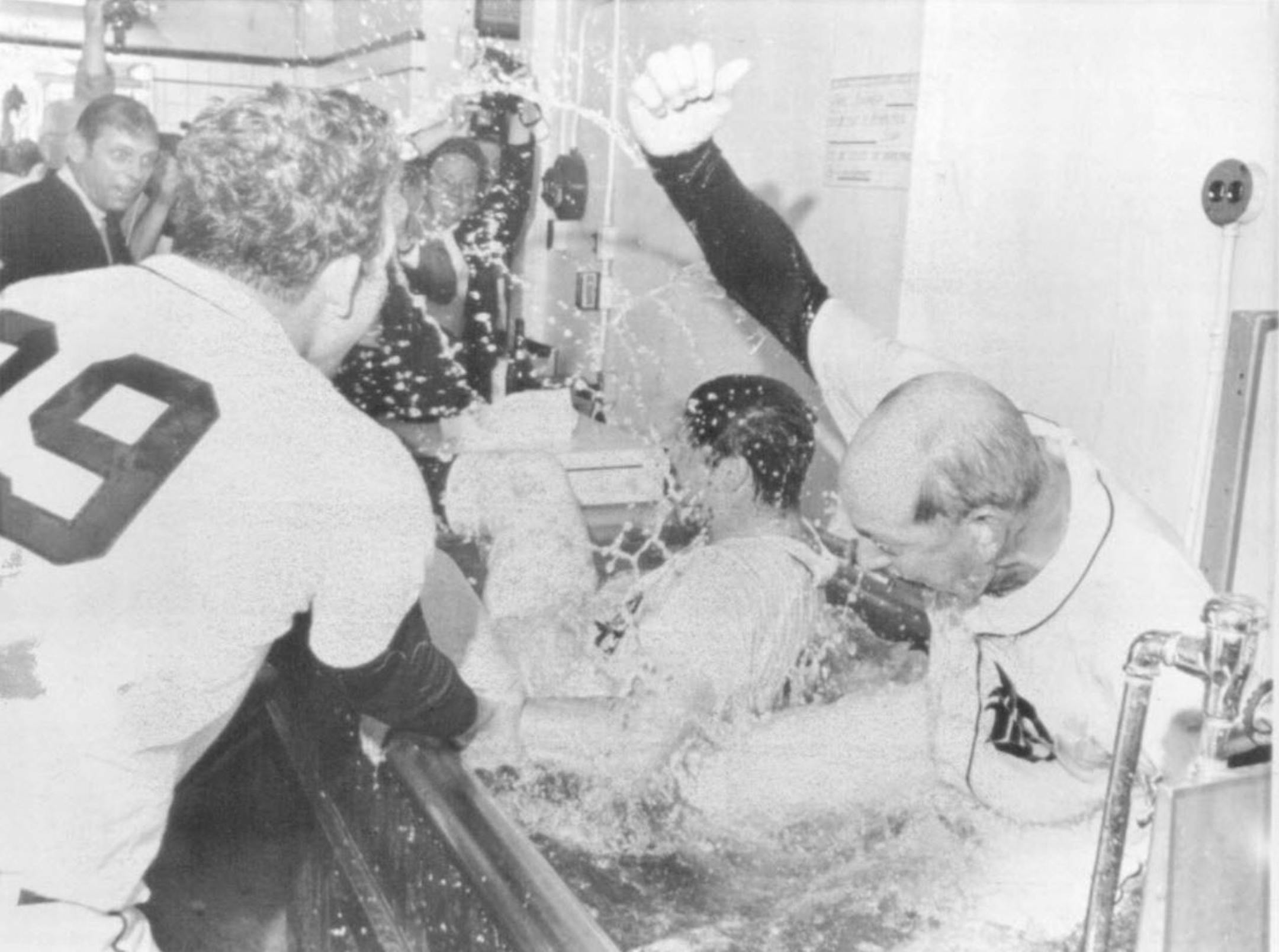 Manager Mayo Smith of the Detroit Tigers tossed into a whirlpool bath by pitcher Mickey Lolich, left, after the Tigers won the 1968 American League pennant