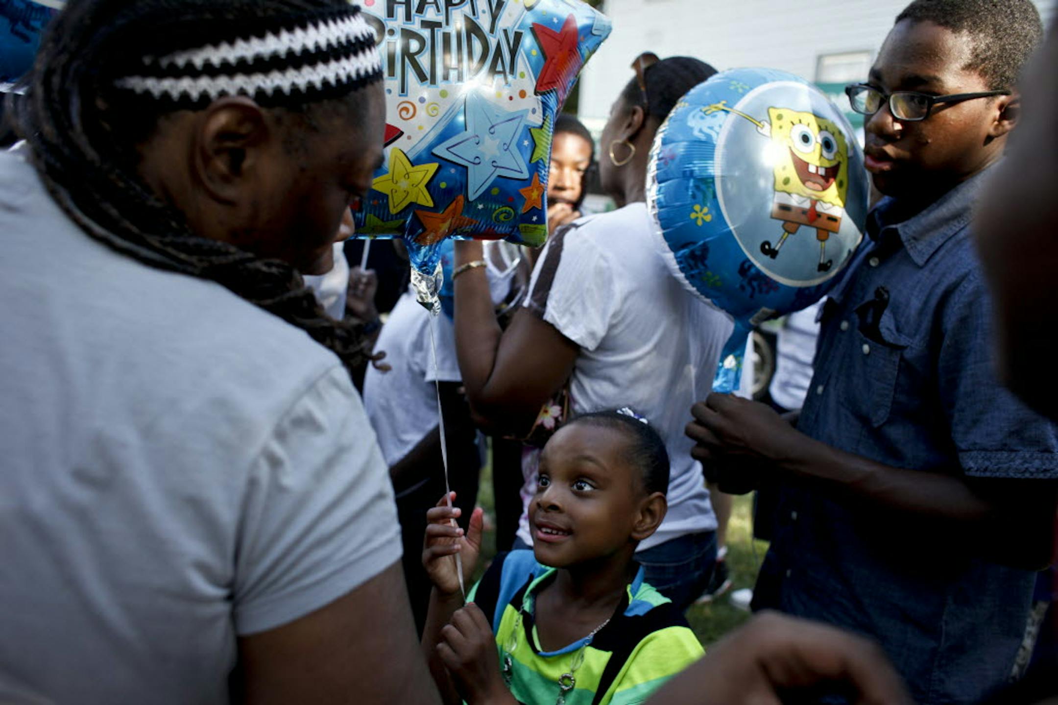 Myneka Horton, 6, held a balloon Sunday commemorating the fourth birthday of Terrell Mayes Jr., who was killed by a bullet fired into his north Minneapolis house the day after Christmas. Myneka talked with Rita Neal, Terrell's grandmother. No arrests have been made.