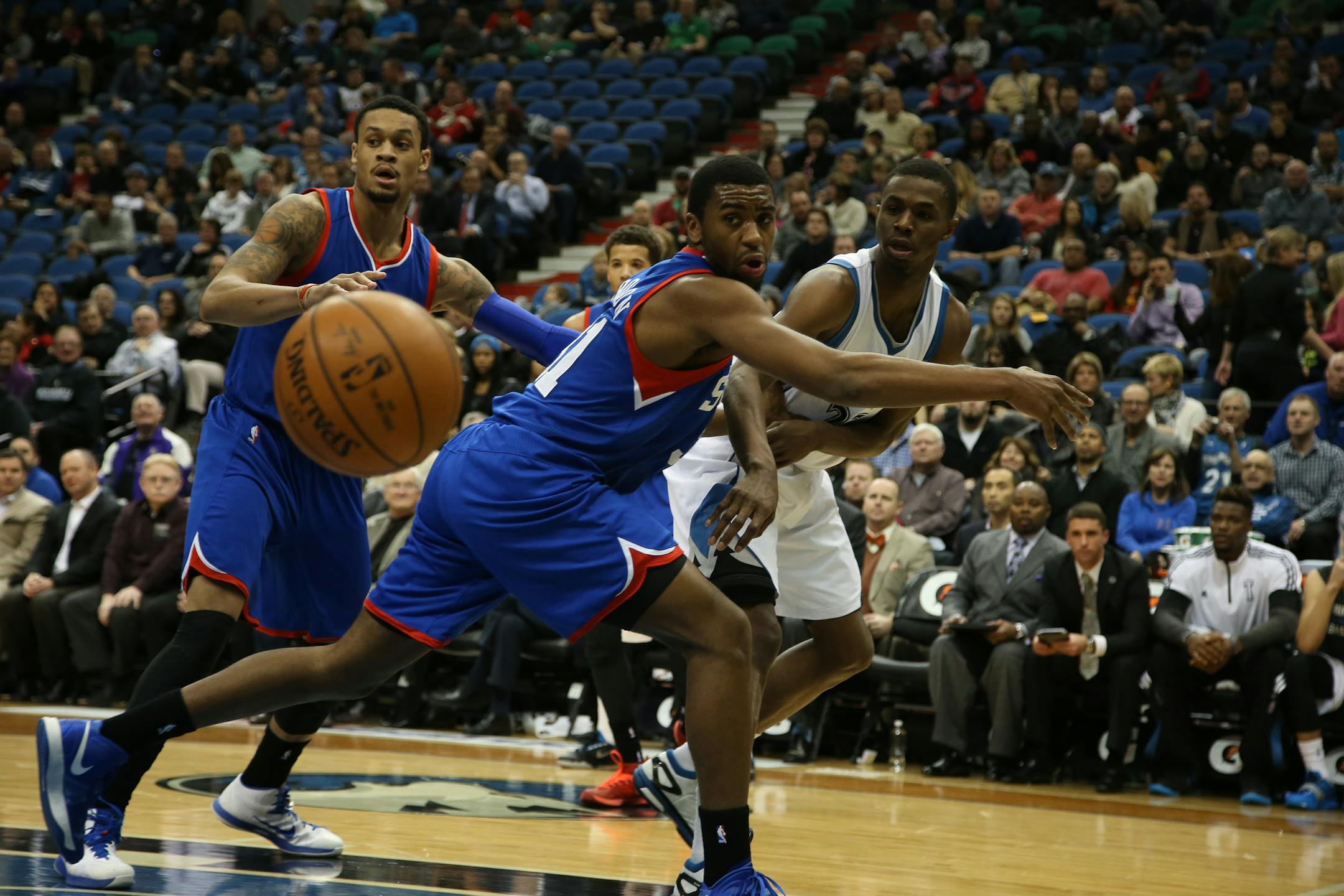 Wolves Andrew Wiggins made a pass on the baseline passed the arm of 76ers Hollis Thompson during the first half.