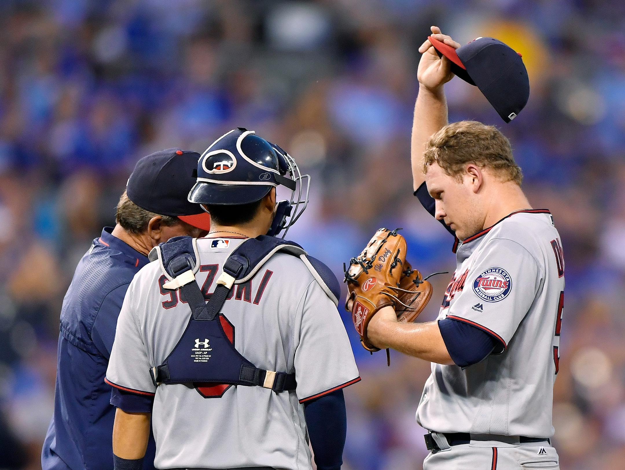 Minnesota Twins starting pitcher Tyler Duffey wipes the sweat away during a visit to the mound in the fourth inning against the Kansas City Royals on Thursday, Aug. 18, 2016, at Kauffman Stadium in Kansas City, Mo. (John Sleezer/Kansas City Star/TNS) ORG XMIT: 1188868