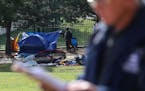 Ricardo Cervantes, director of St. Paul's Department of Safety and Inspections, read a statement as a homeless encampment near downtown St. Paul and I