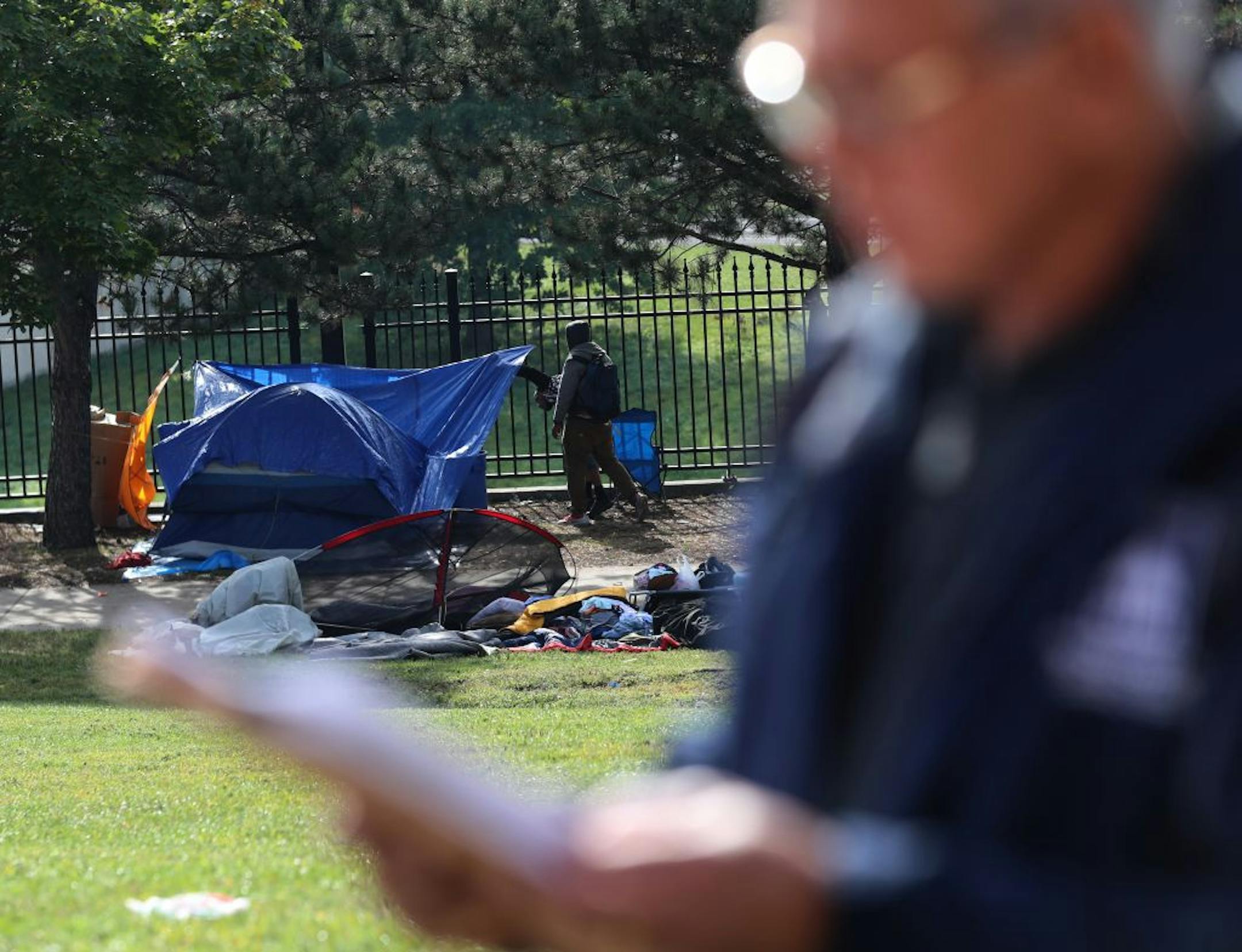 Ricardo Cervantes, director of St. Paul's Department of Safety and Inspections, read a statement as a homeless encampment near downtown St. Paul and Interstate 35E was cleared on Sept. 10.